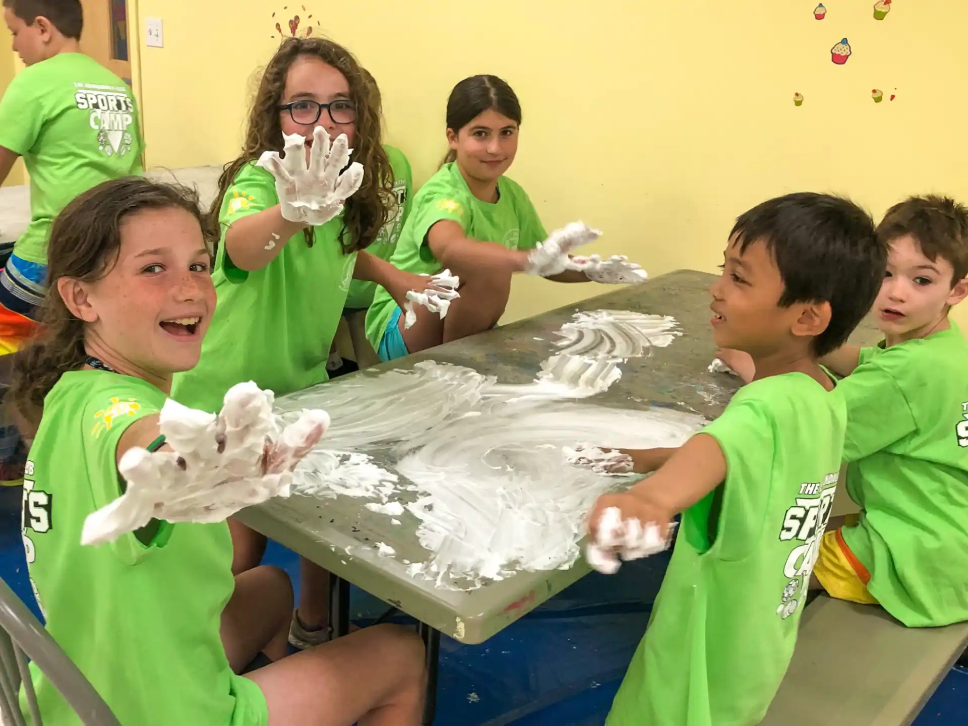 a group of children wearing green shirts