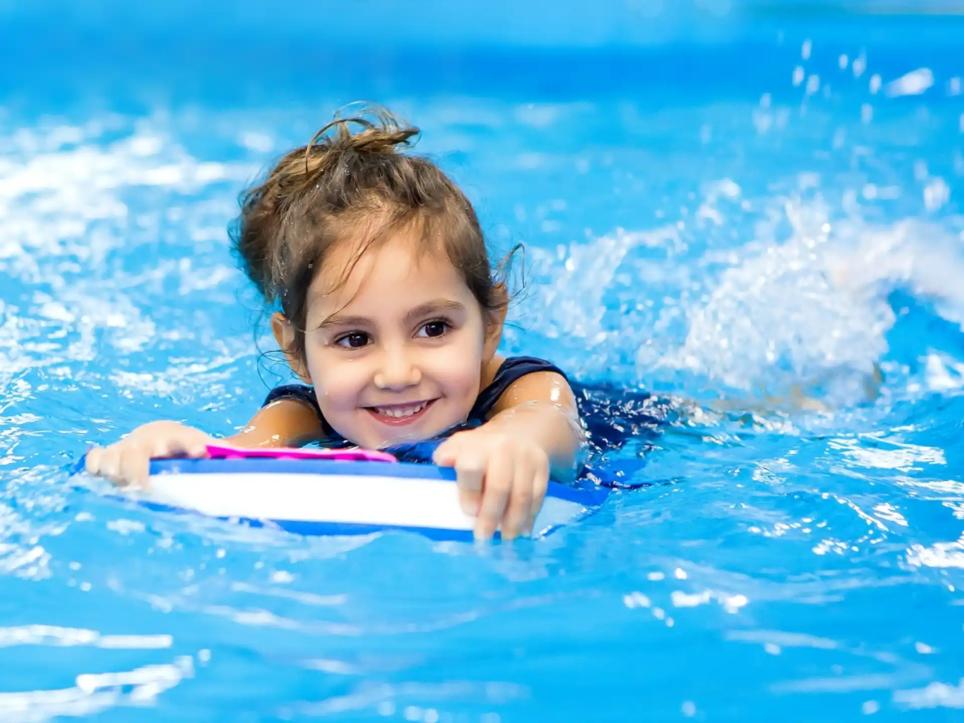 a girl swimming in a pool