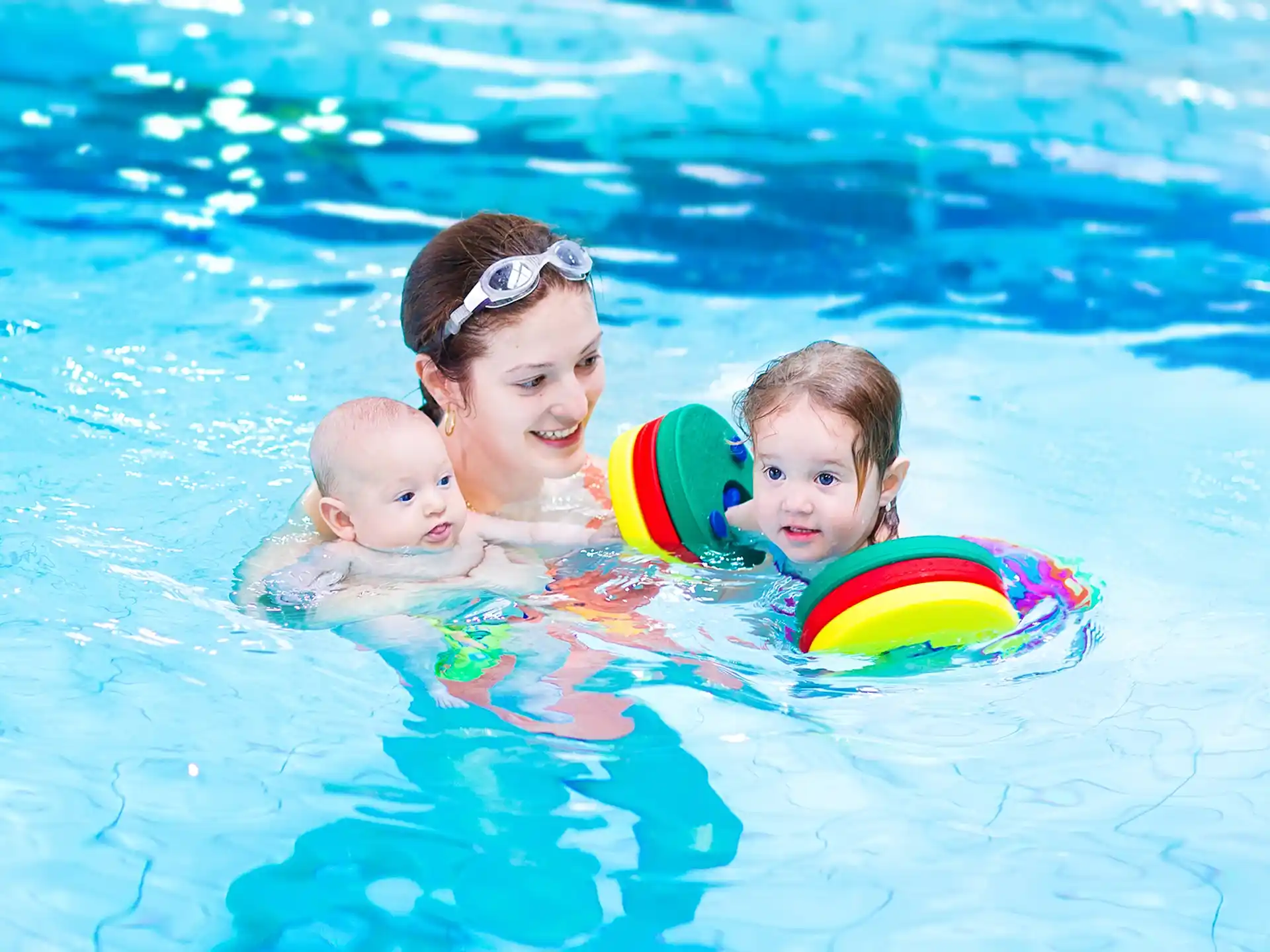 a person and two children in a pool