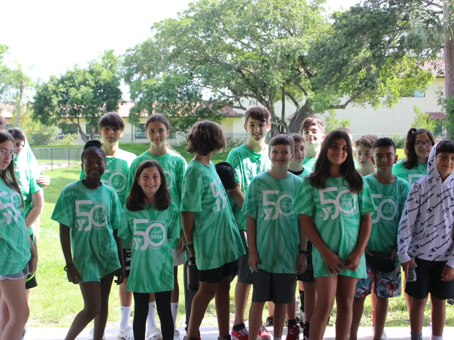 a group of people wearing matching green shirts