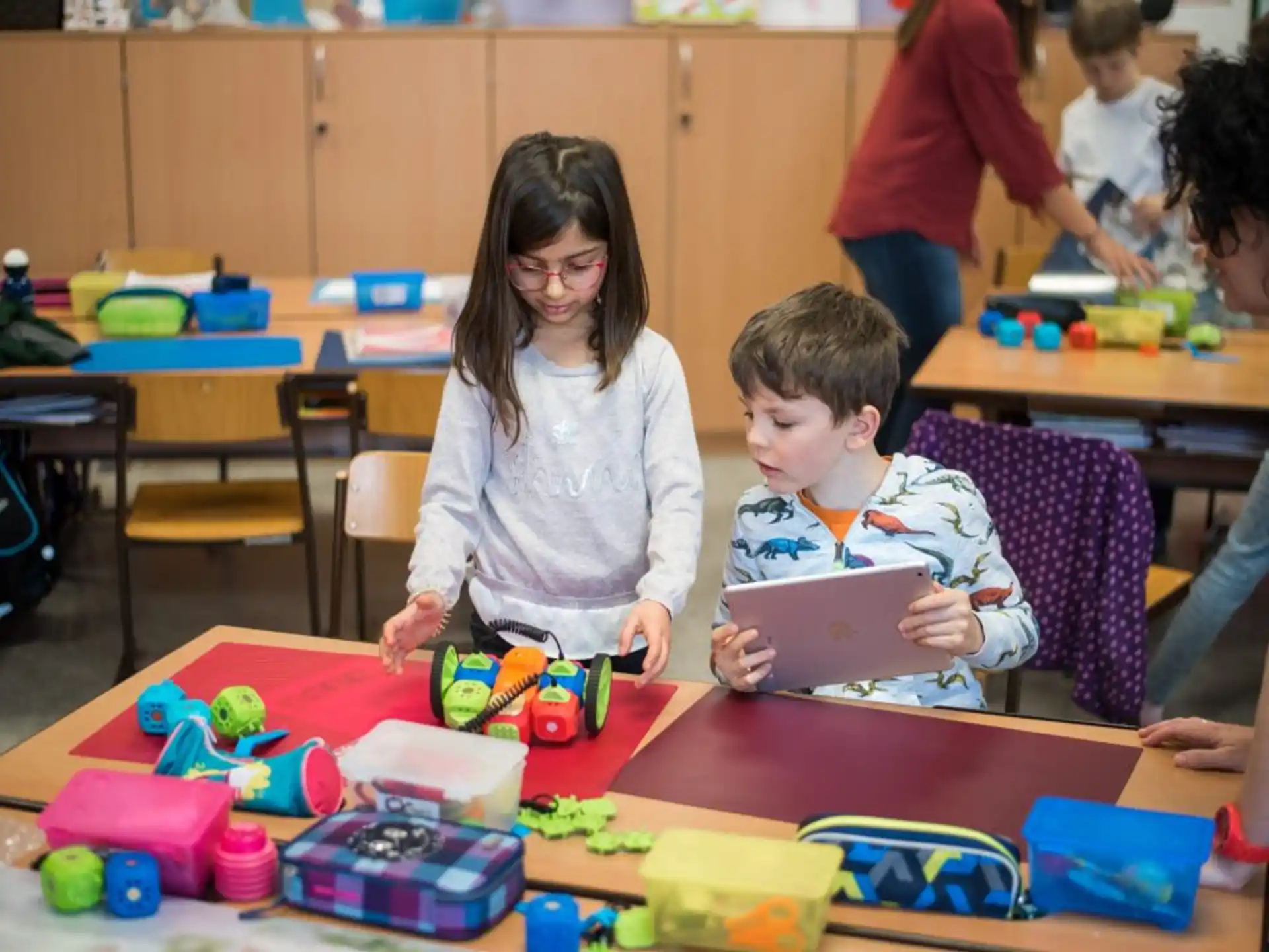 a person and a boy playing with toys