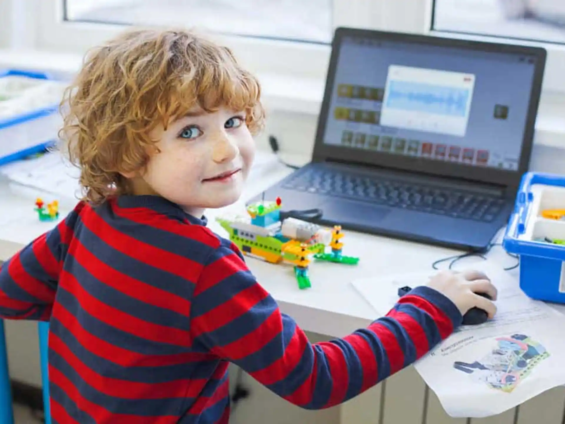 a young boy using a computer