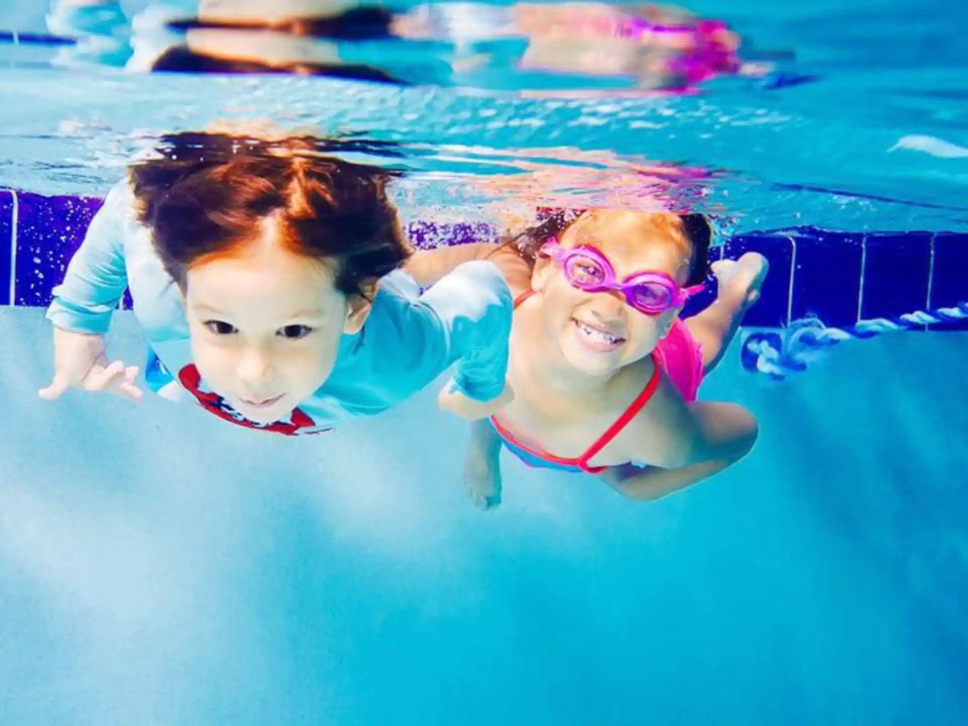 a person and a baby in a pool