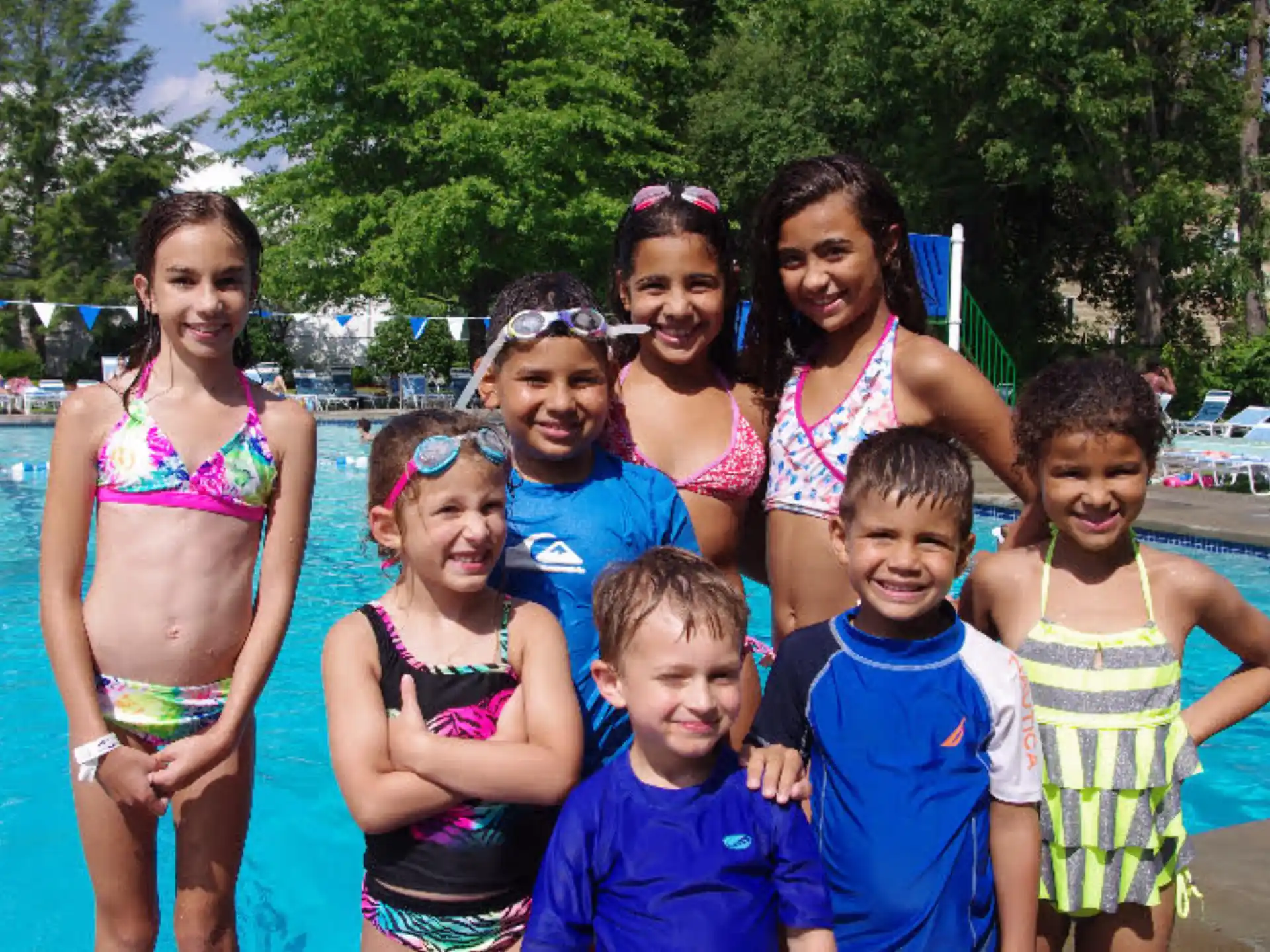 a group of people posing for a photo in a pool