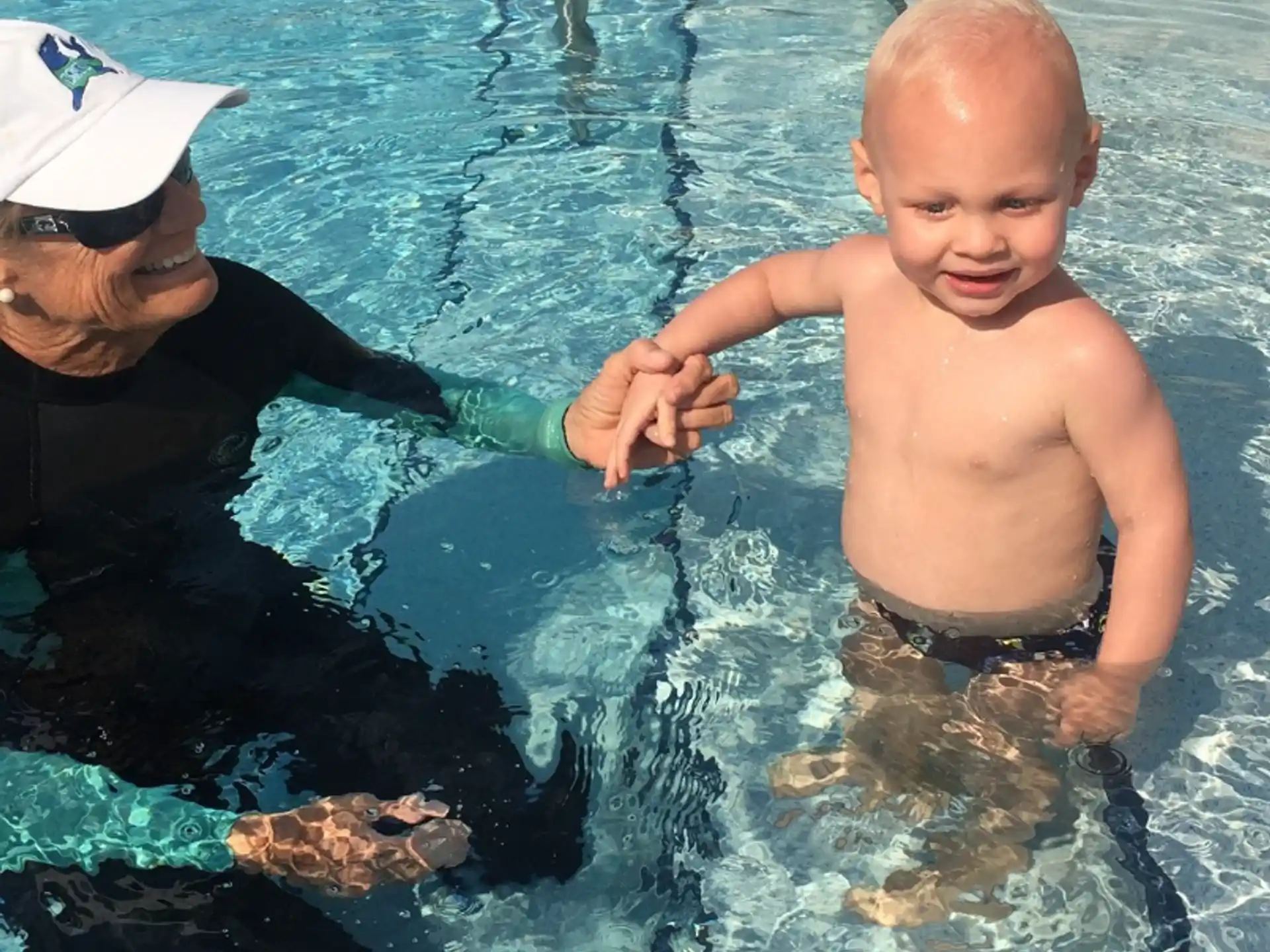 a person and a baby in a pool
