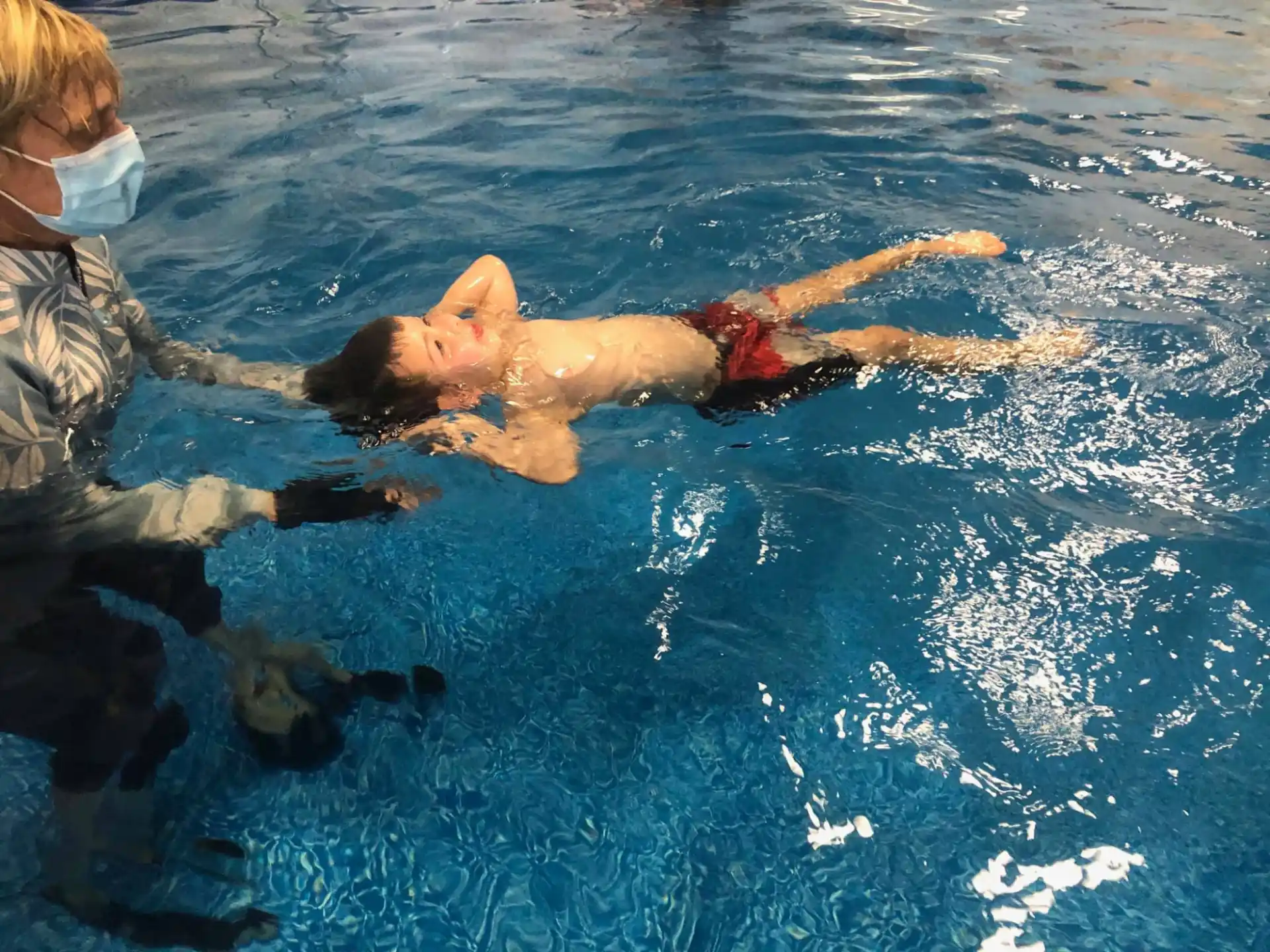 a person in the water with a dolphin