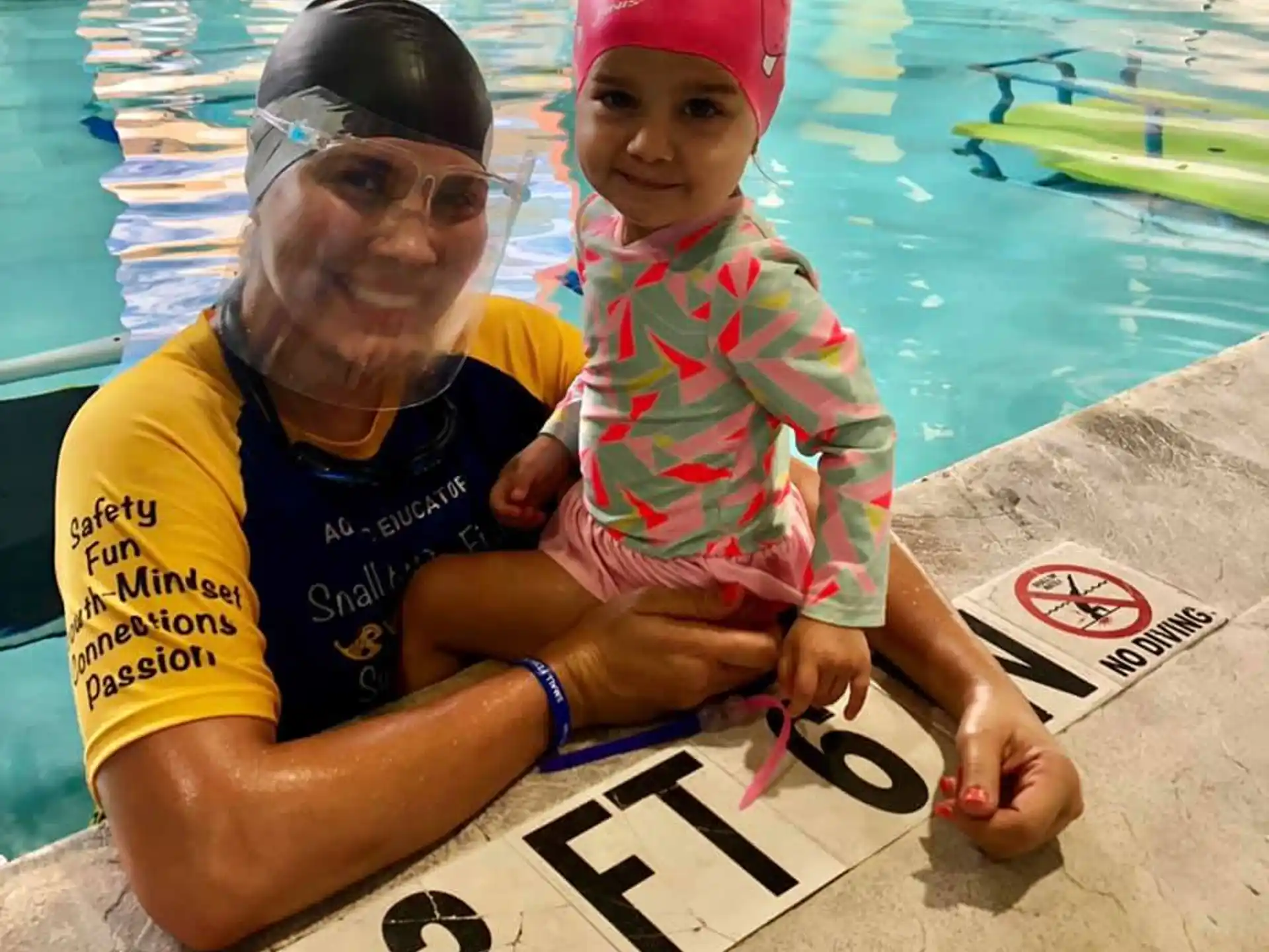 a person and a child in a pool