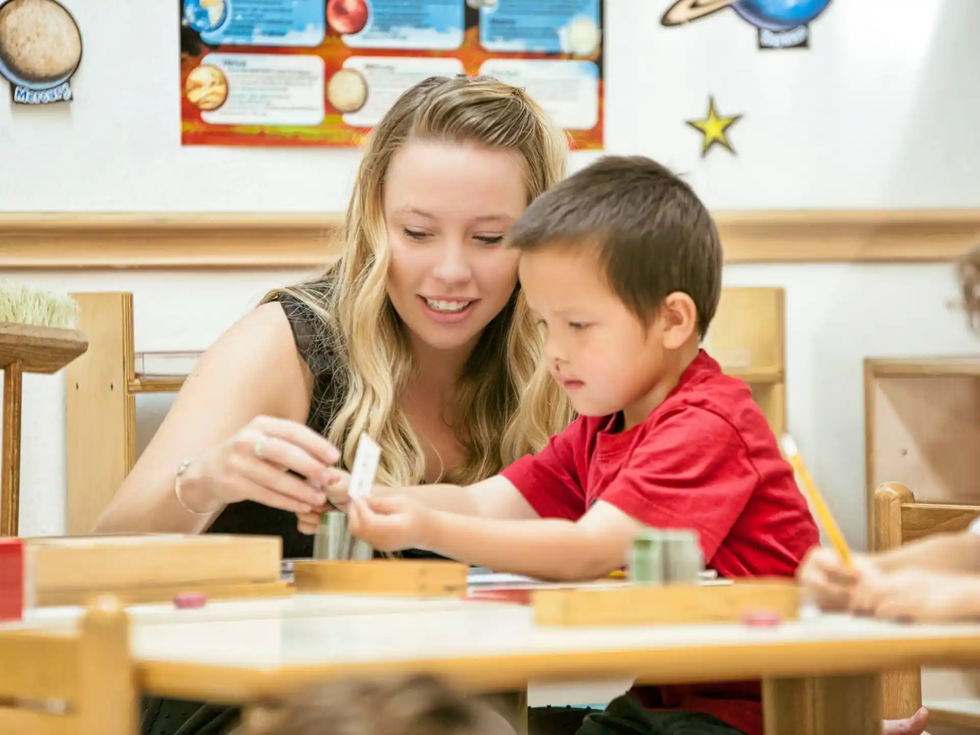 a person and a boy sitting at a table