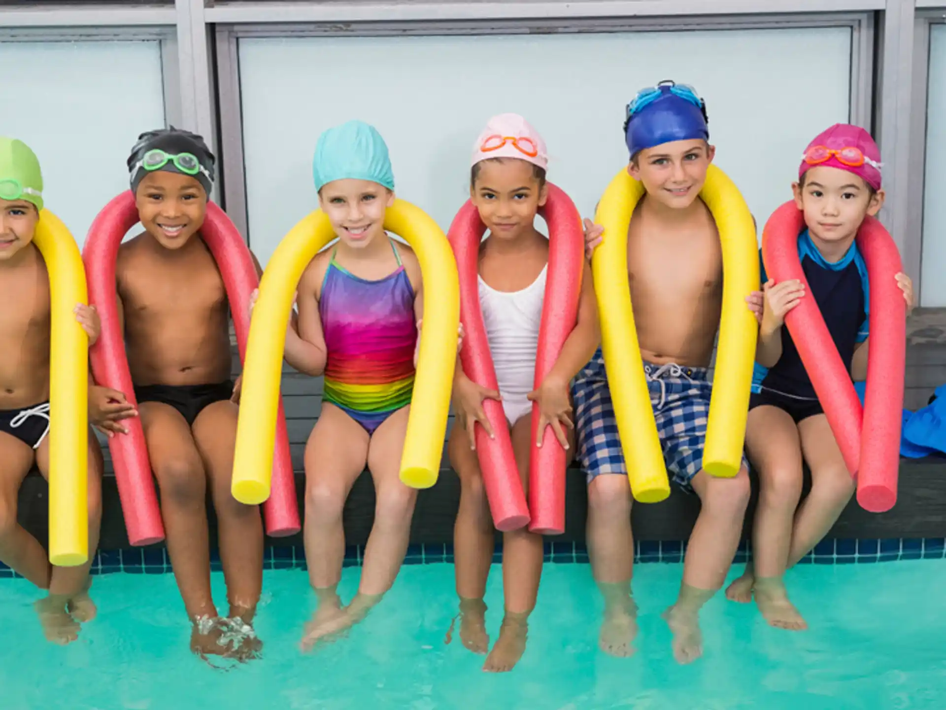 a group of people in swimsuits posing for a photo