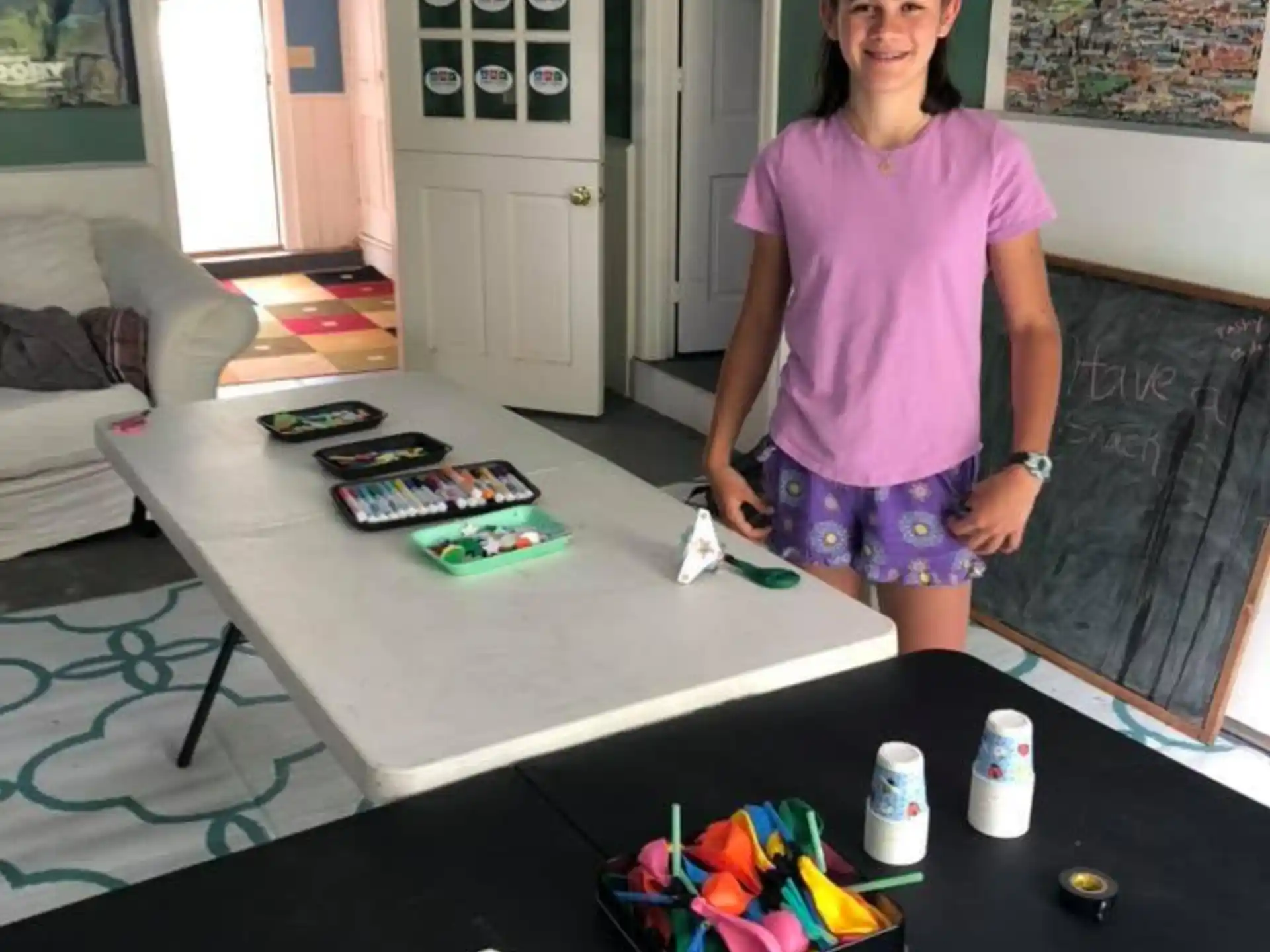 a person standing next to a table with objects on it
