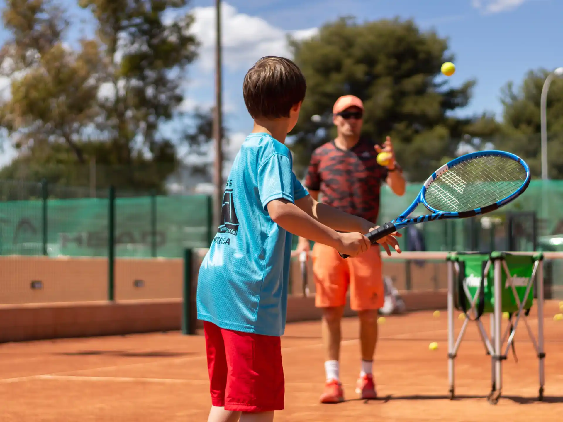 a couple of boys playing tennis