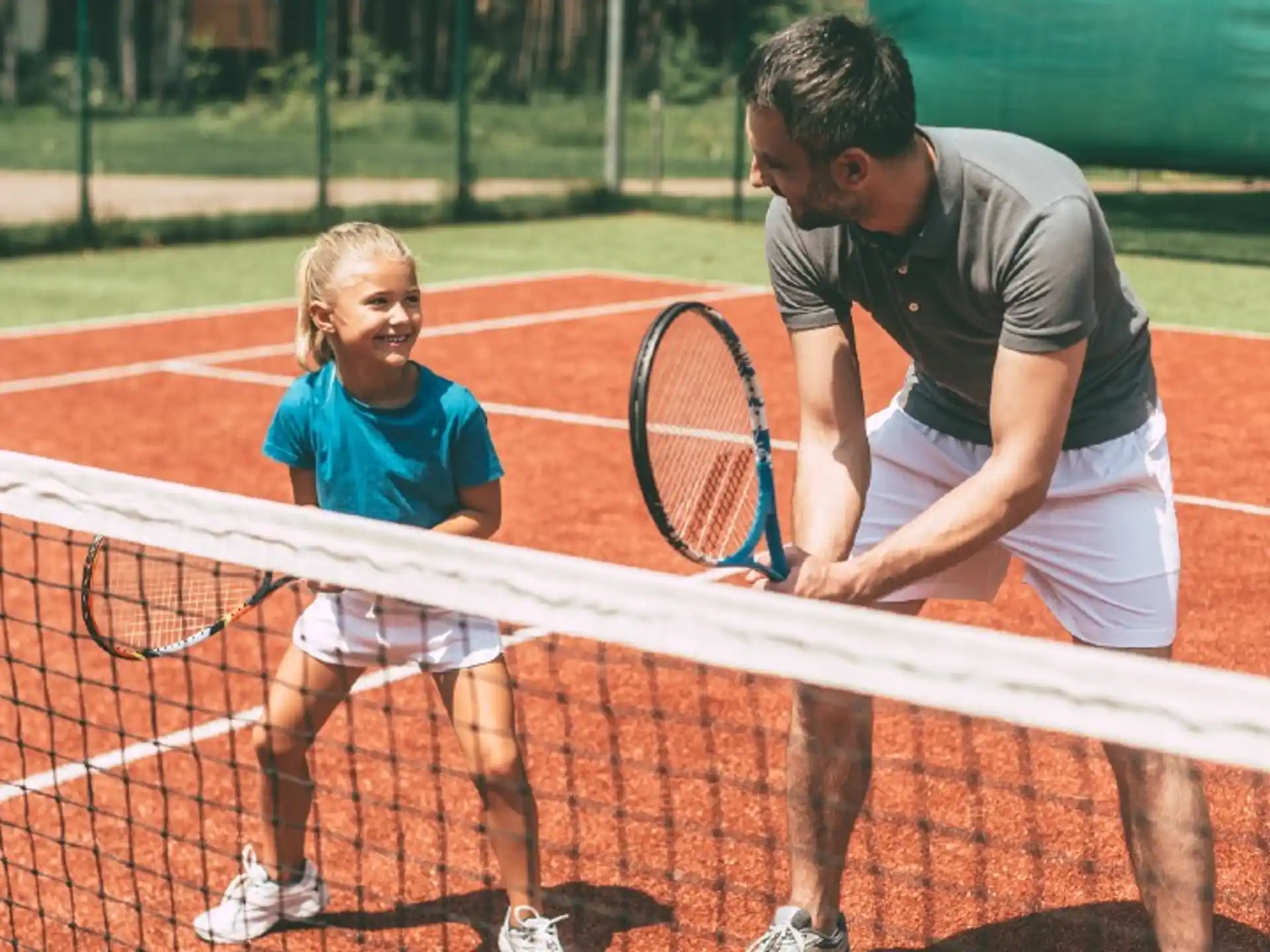 a man and a woman holding tennis rackets