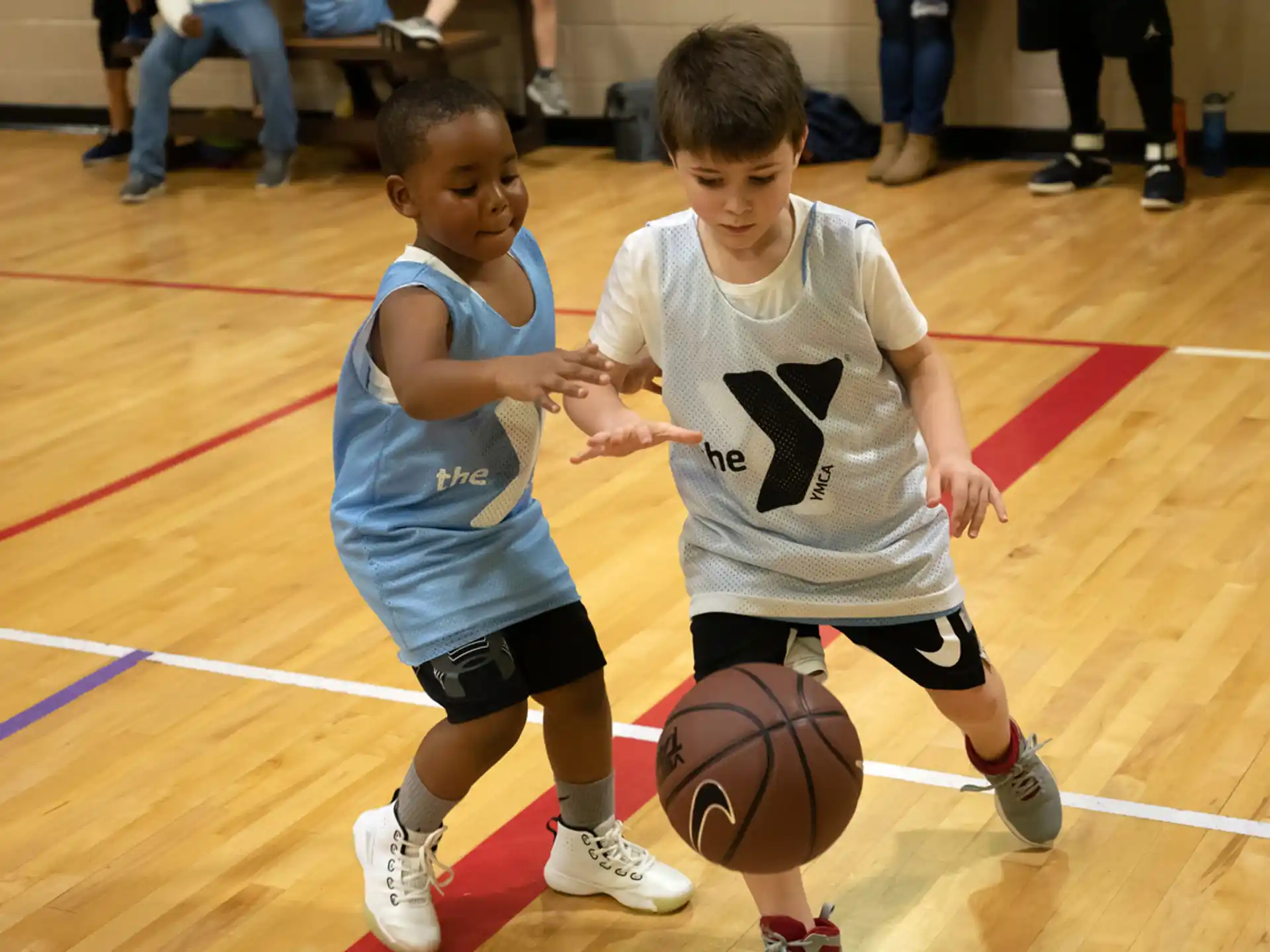 a couple of boys playing basketball