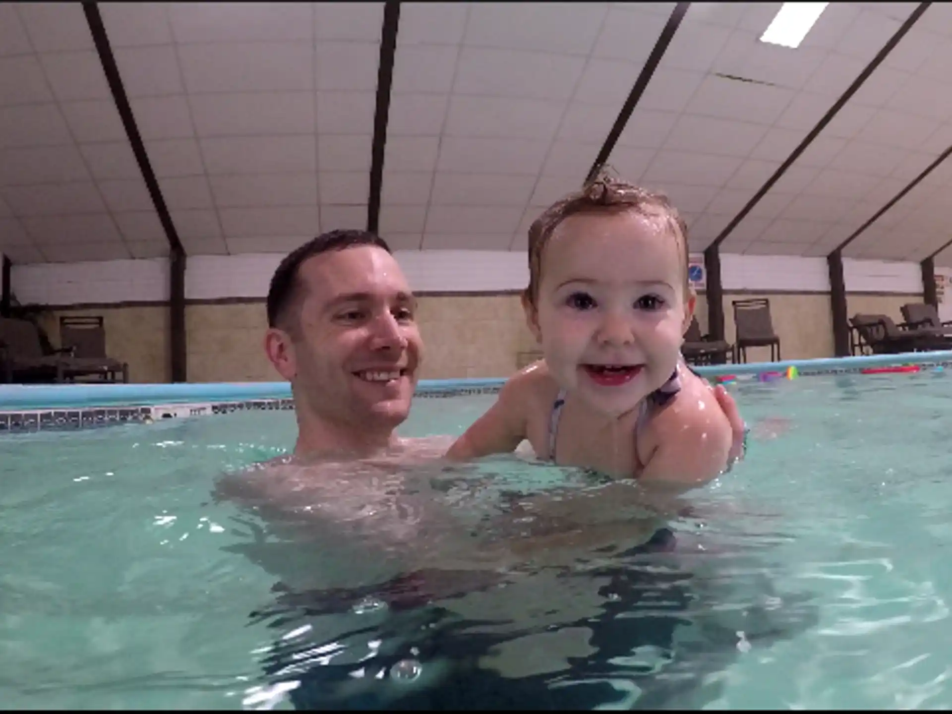 a woman and a child in a pool