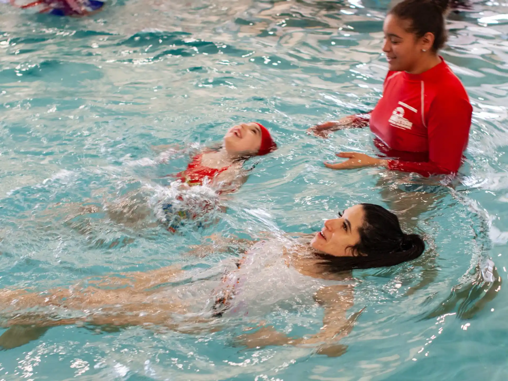 a person and a baby in a pool
