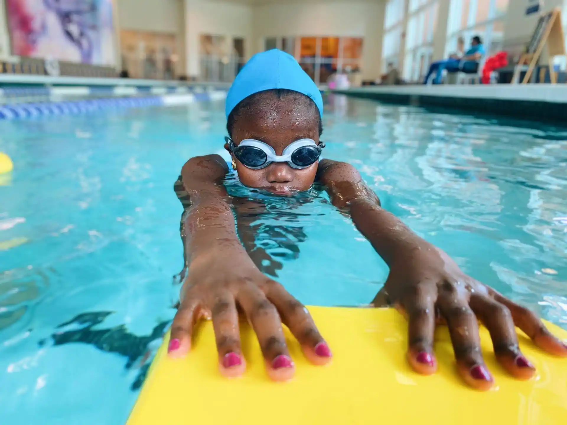 a person in a pool with a seal on the back