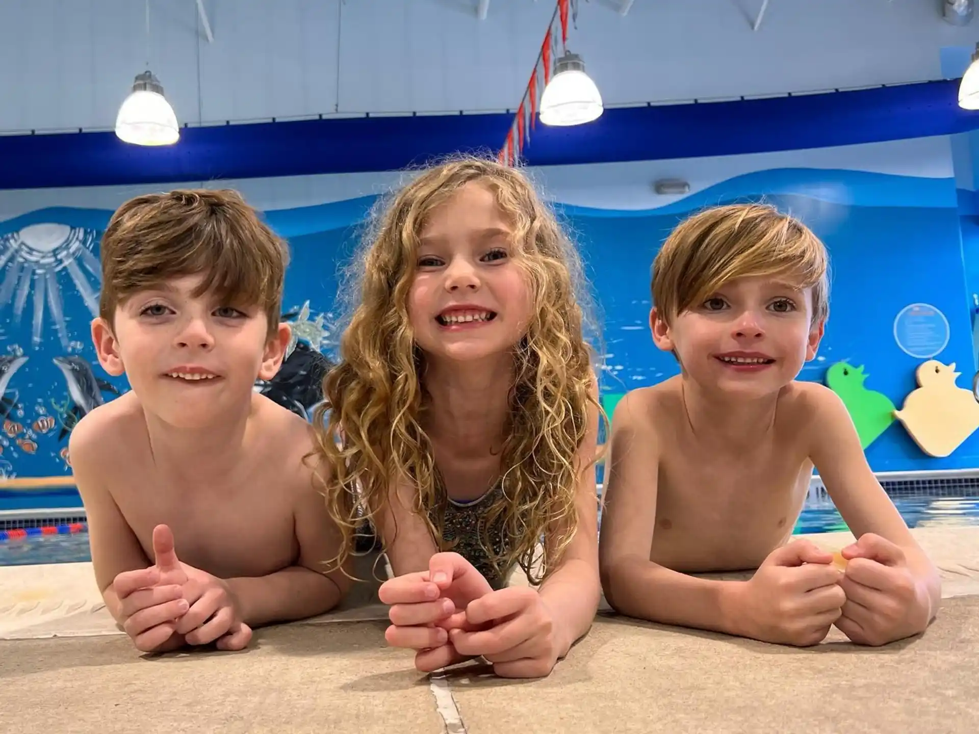 a group of kids in a swimming pool
