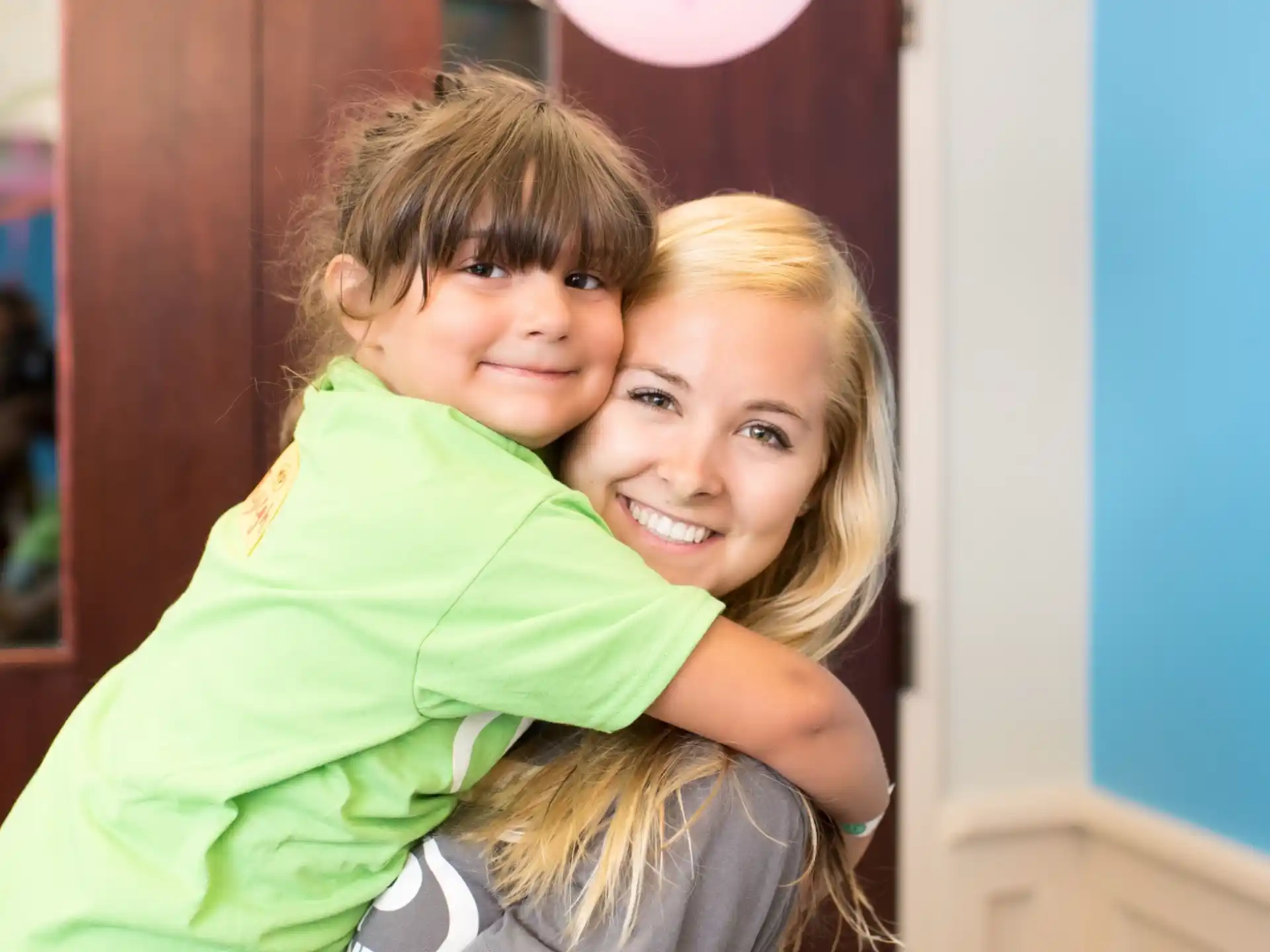a person hugging a boy