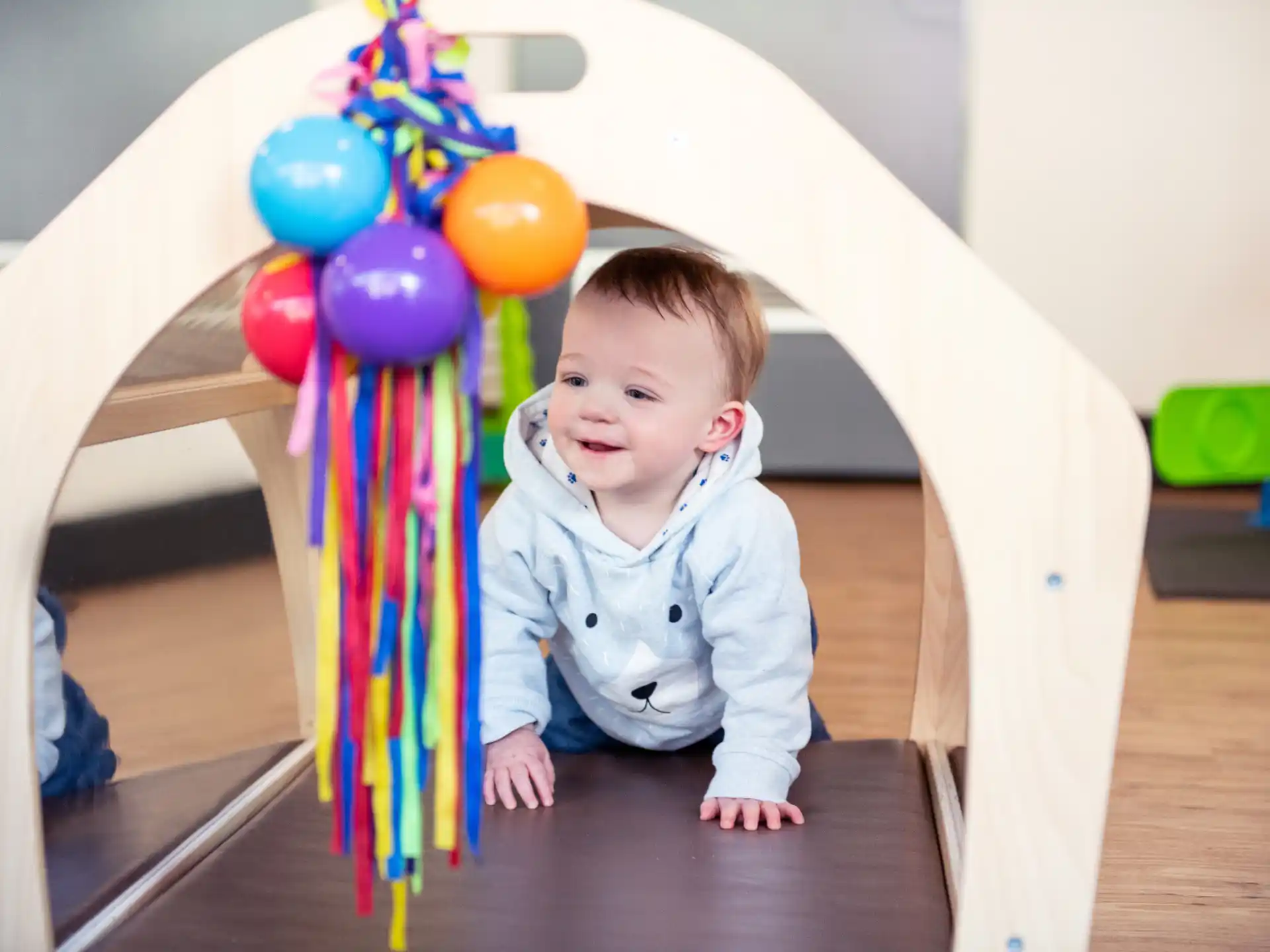 a baby sitting on a table with balloons