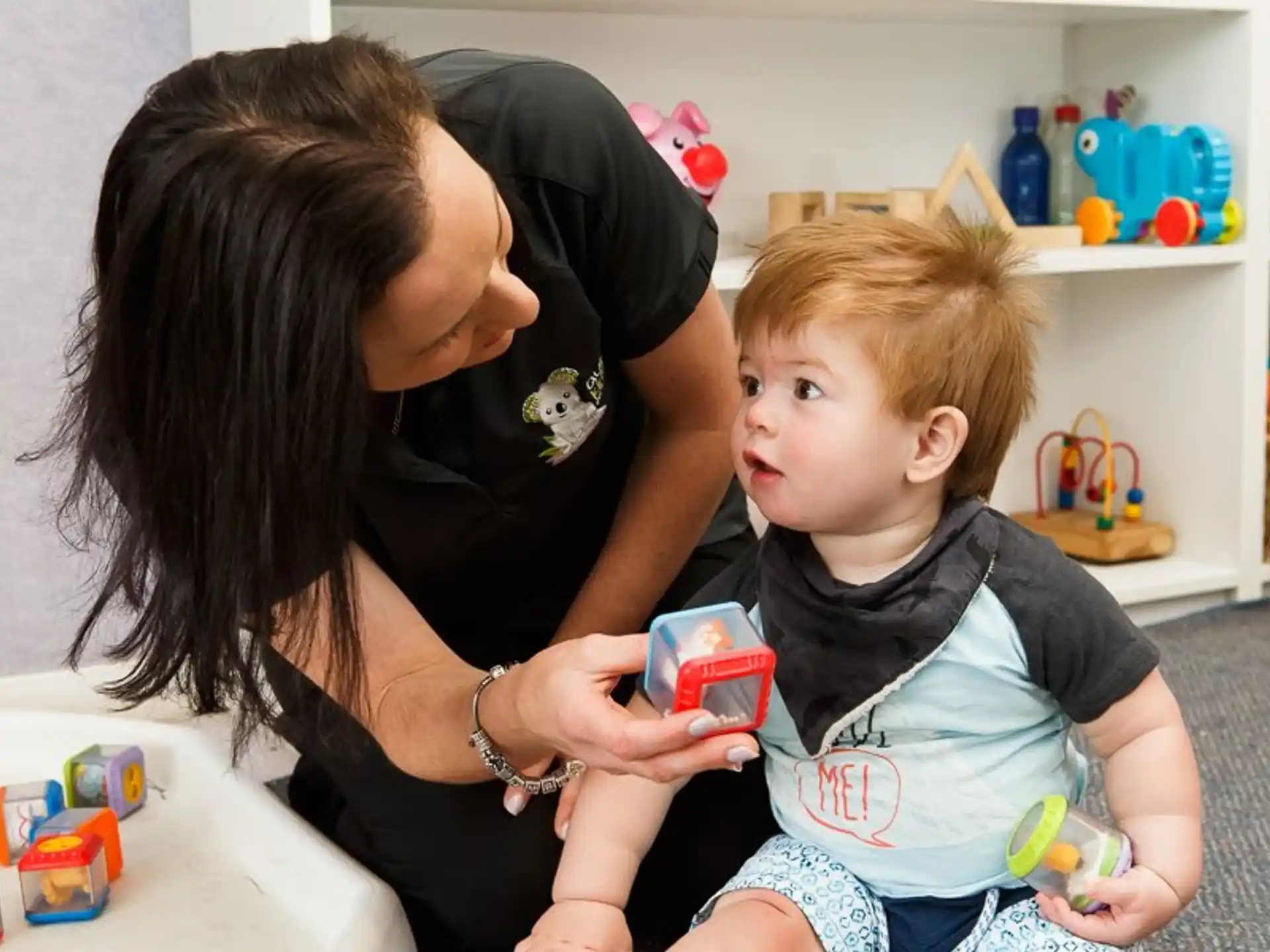 a person and a child playing with a toy
