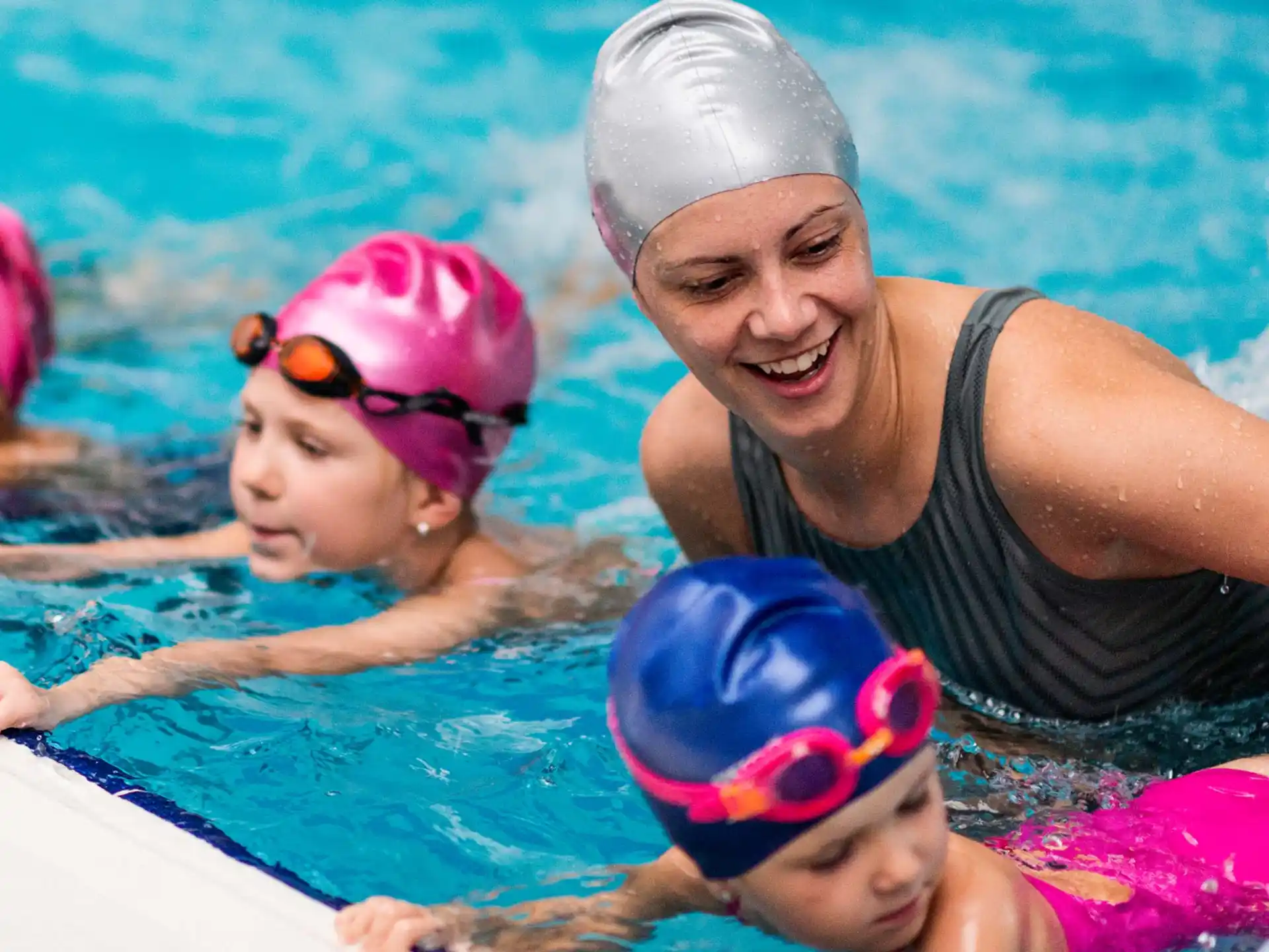 a person and two children in a pool