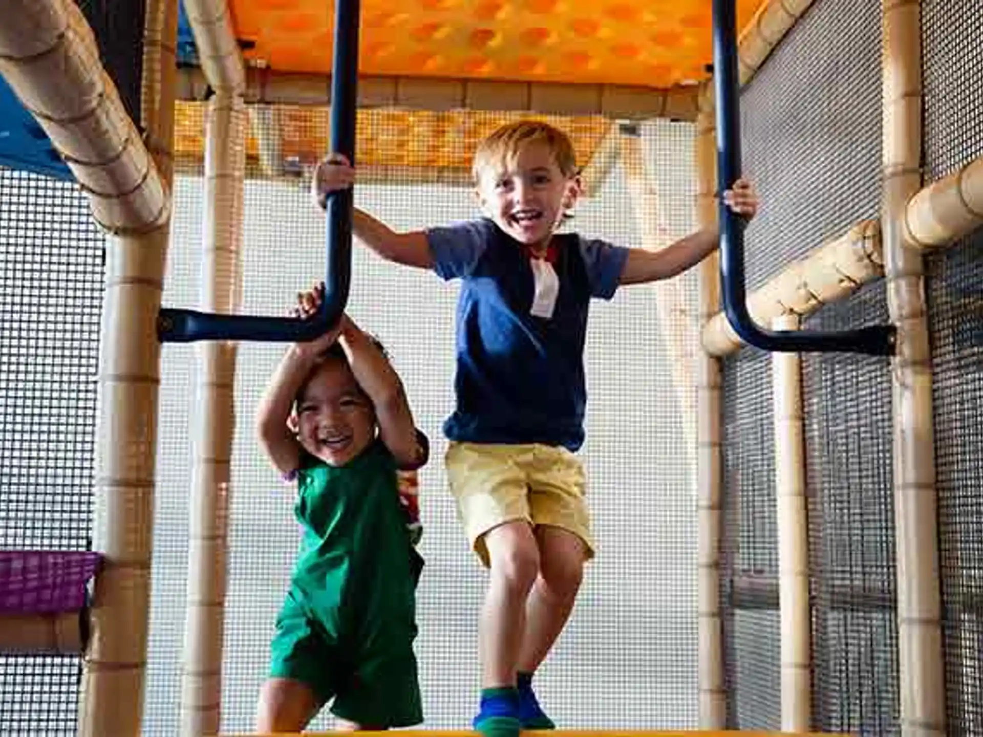 a couple of kids playing on a playground