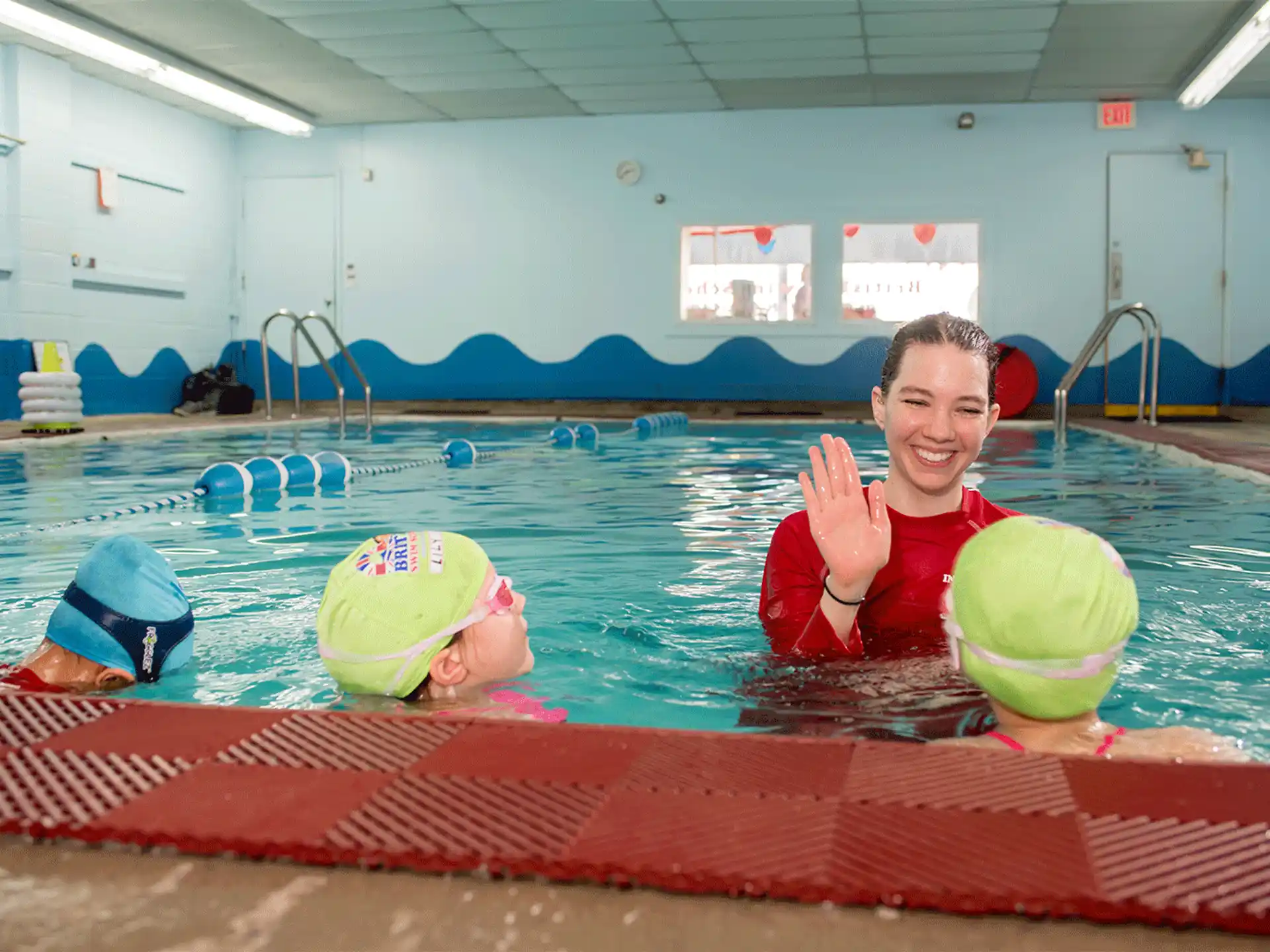 a person and a boy in a pool with balls