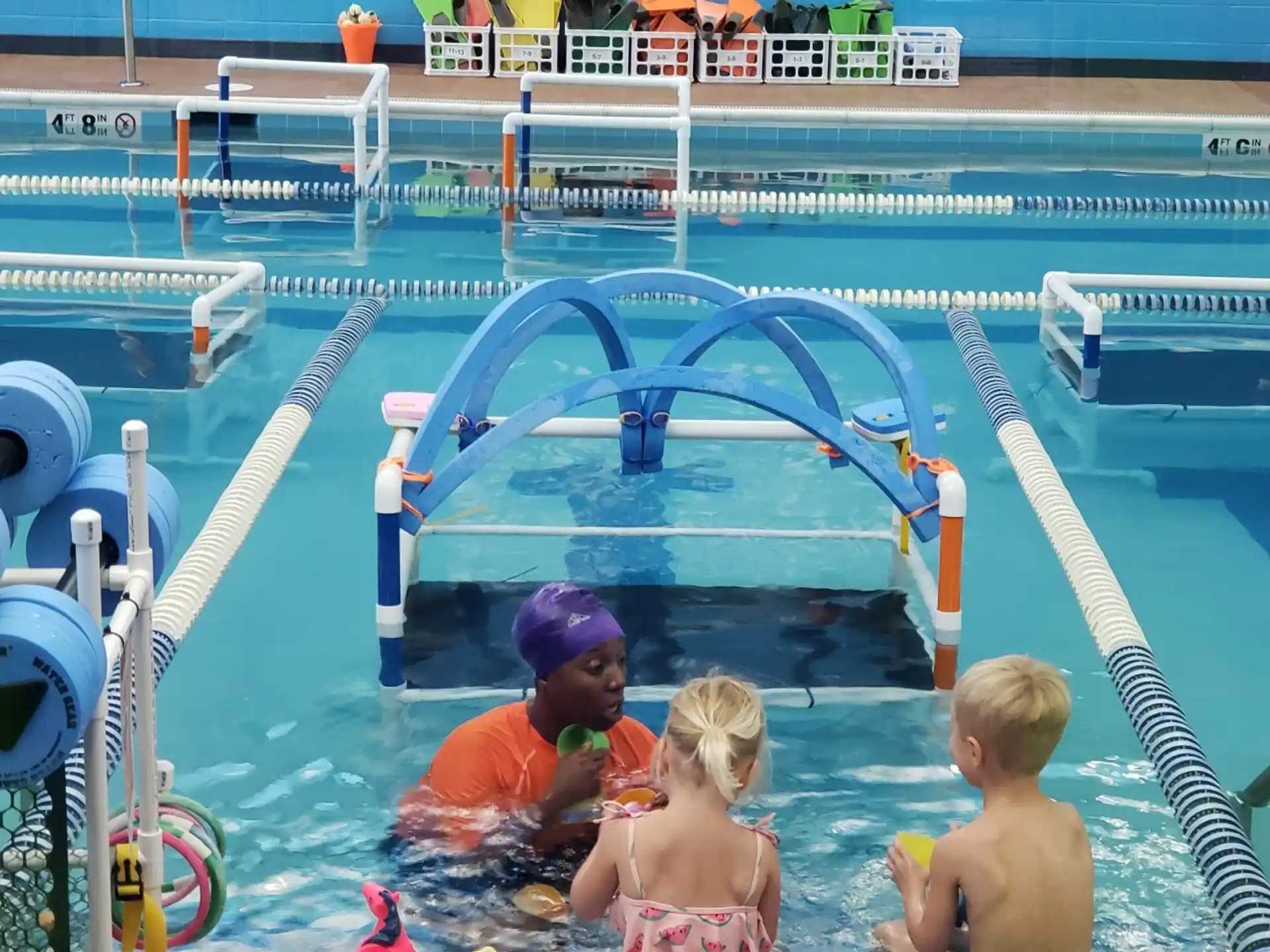 a group of kids playing in a pool
