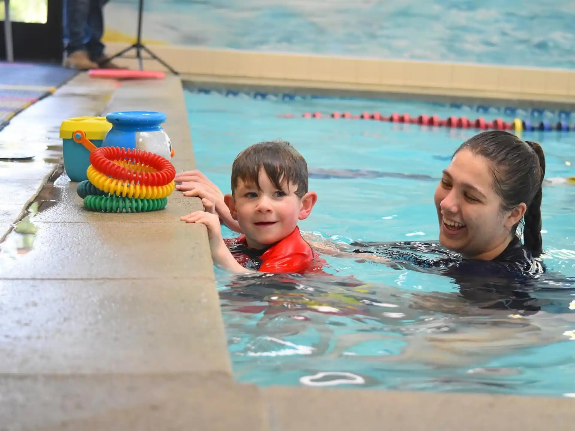 a person and a boy in a pool