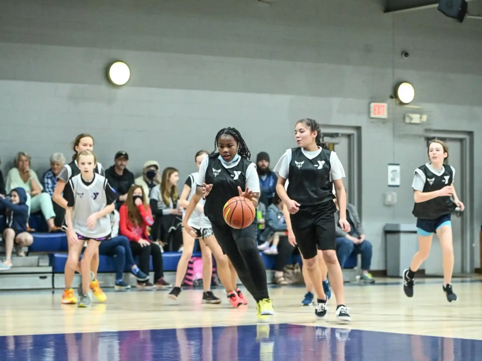 a group of people playing basketball