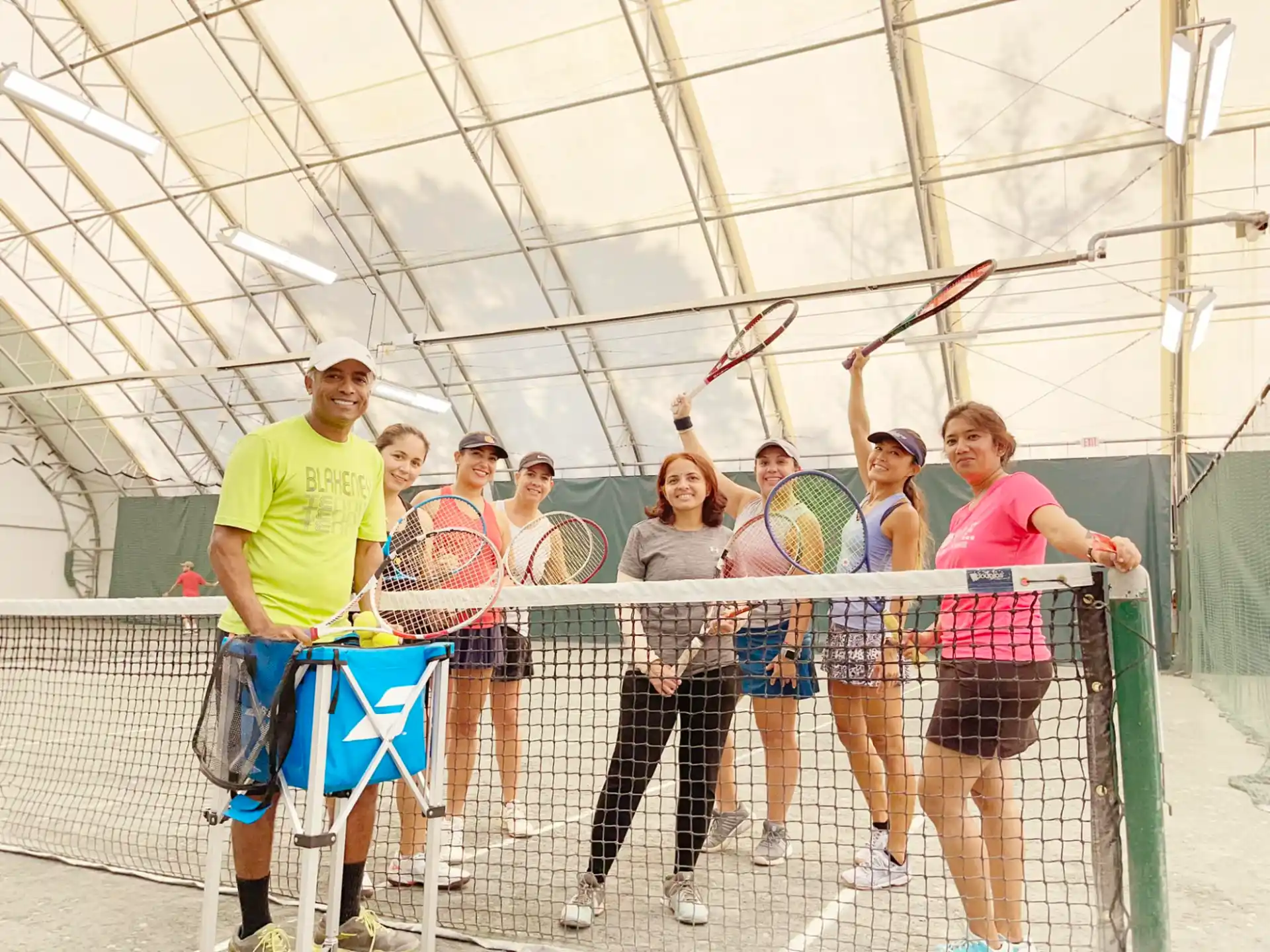 a group of people holding tennis rackets