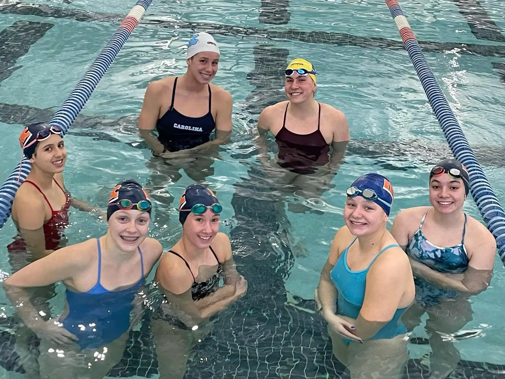 a group of women in garments in the water