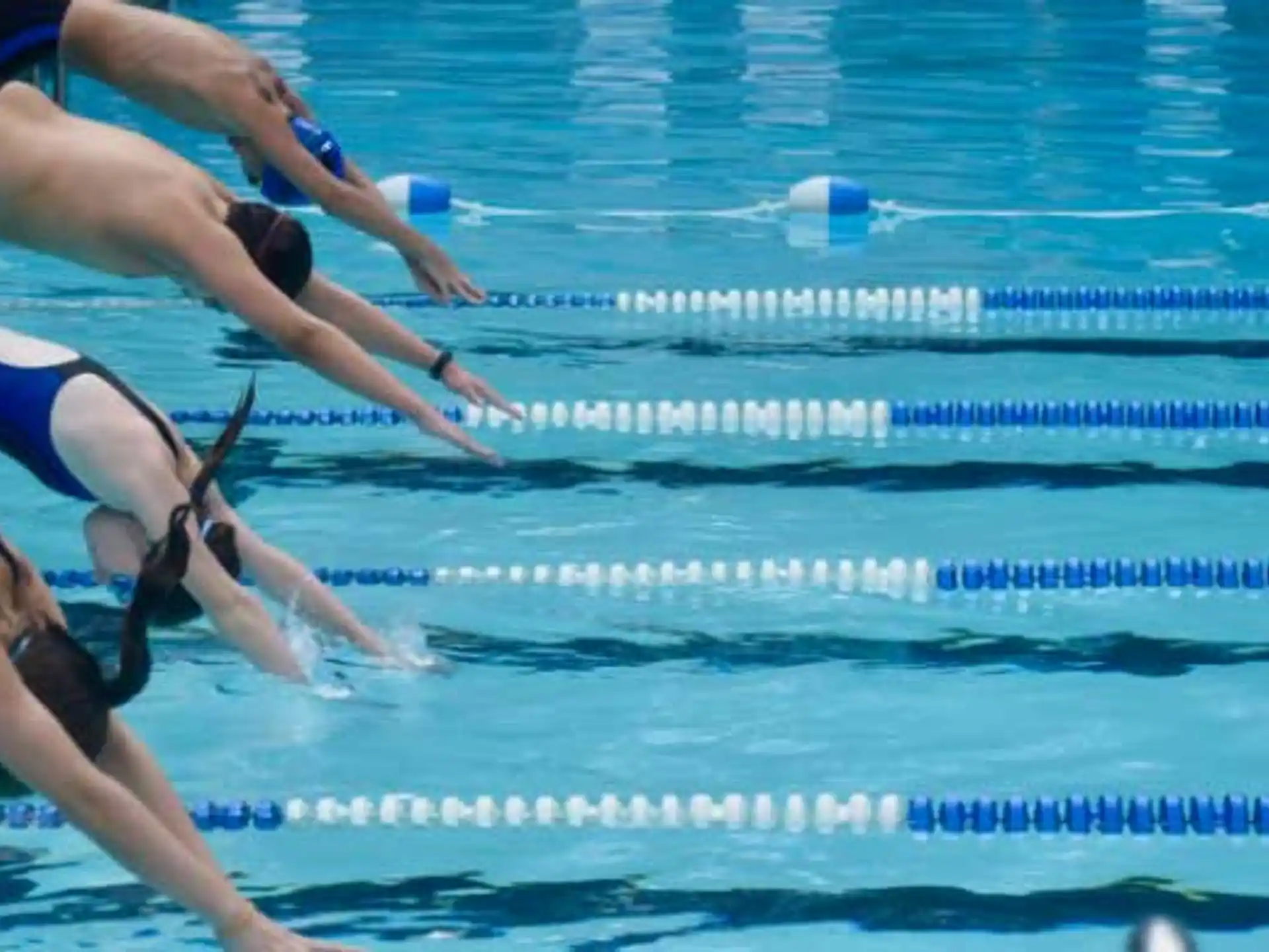 a group of women in swimsuits in a pool