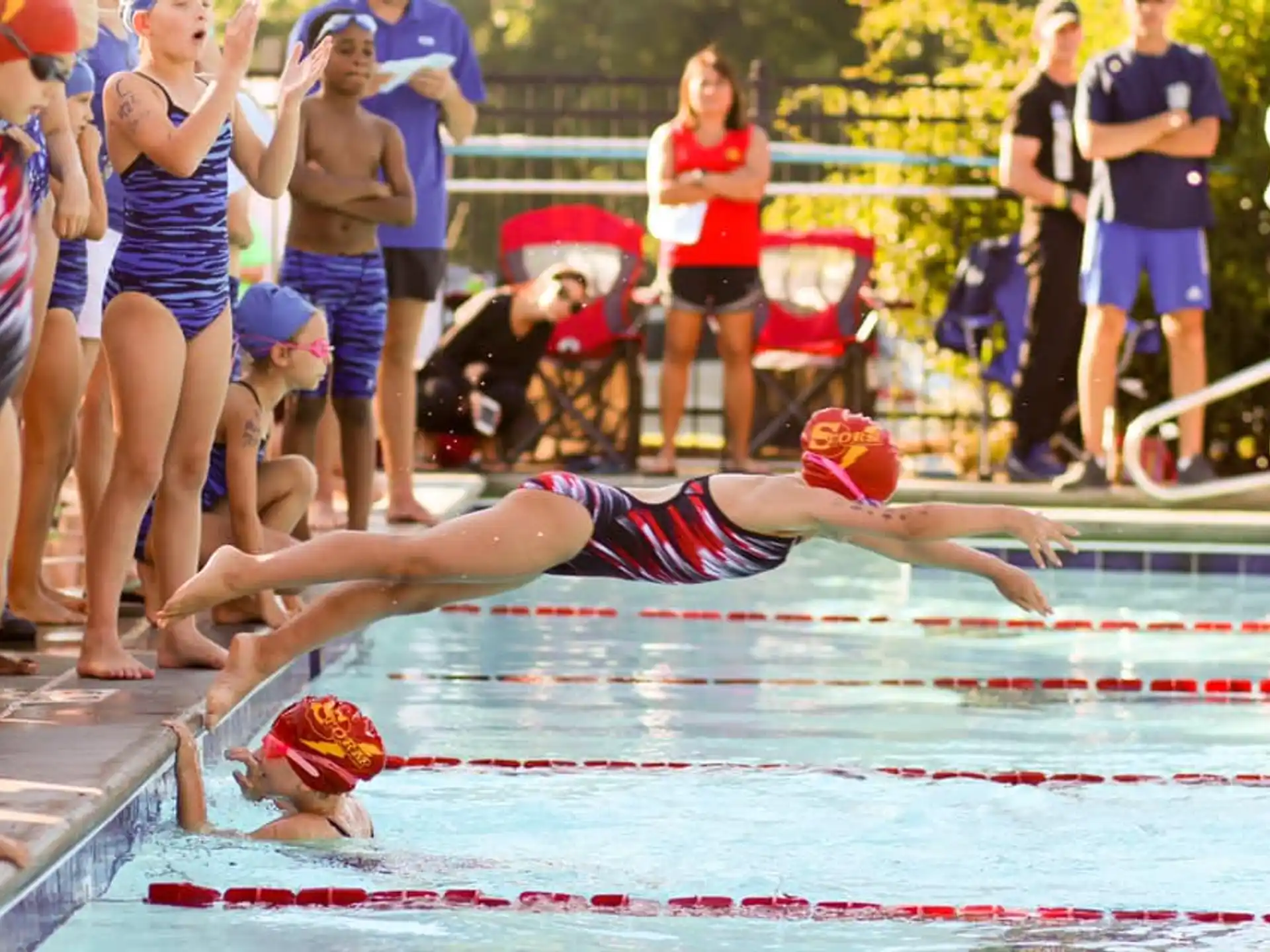 a woman diving into a pool