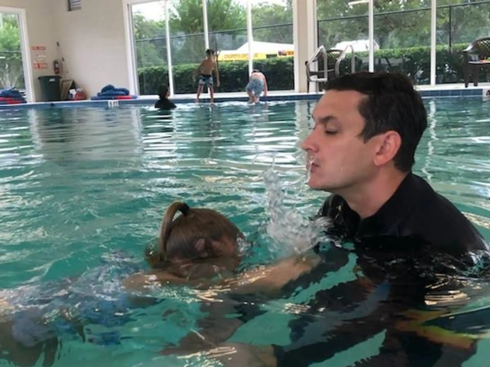 a person and a dog in a pool