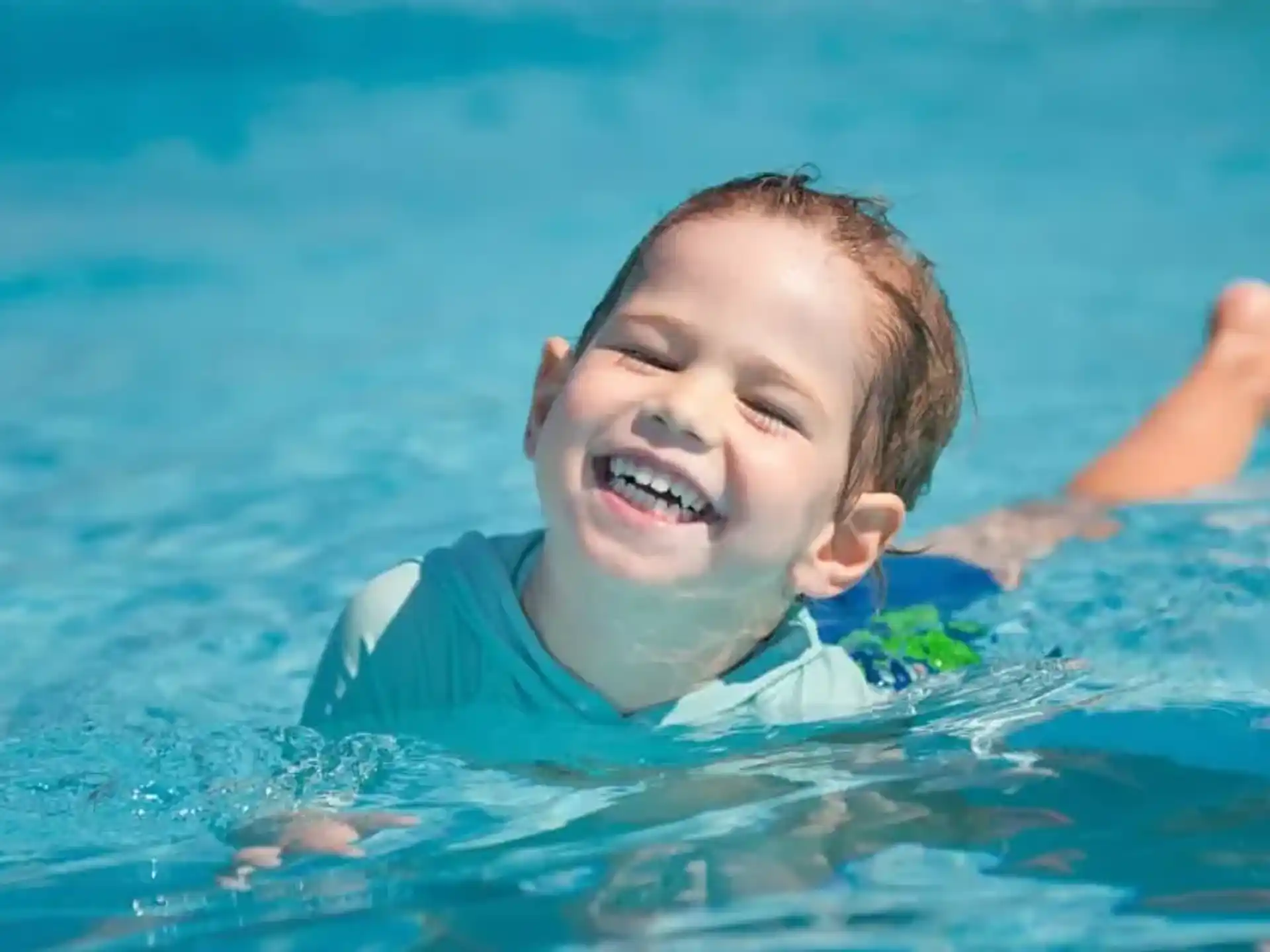 a boy swimming in water