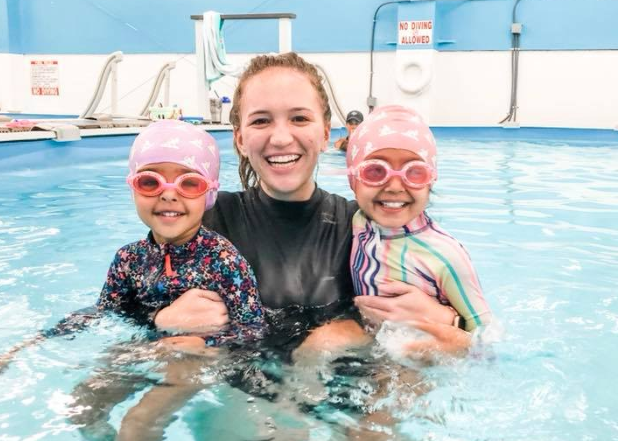 a person and two children in a pool