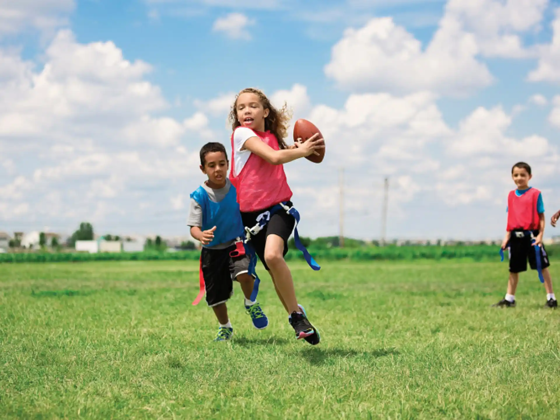 a group of kids playing football