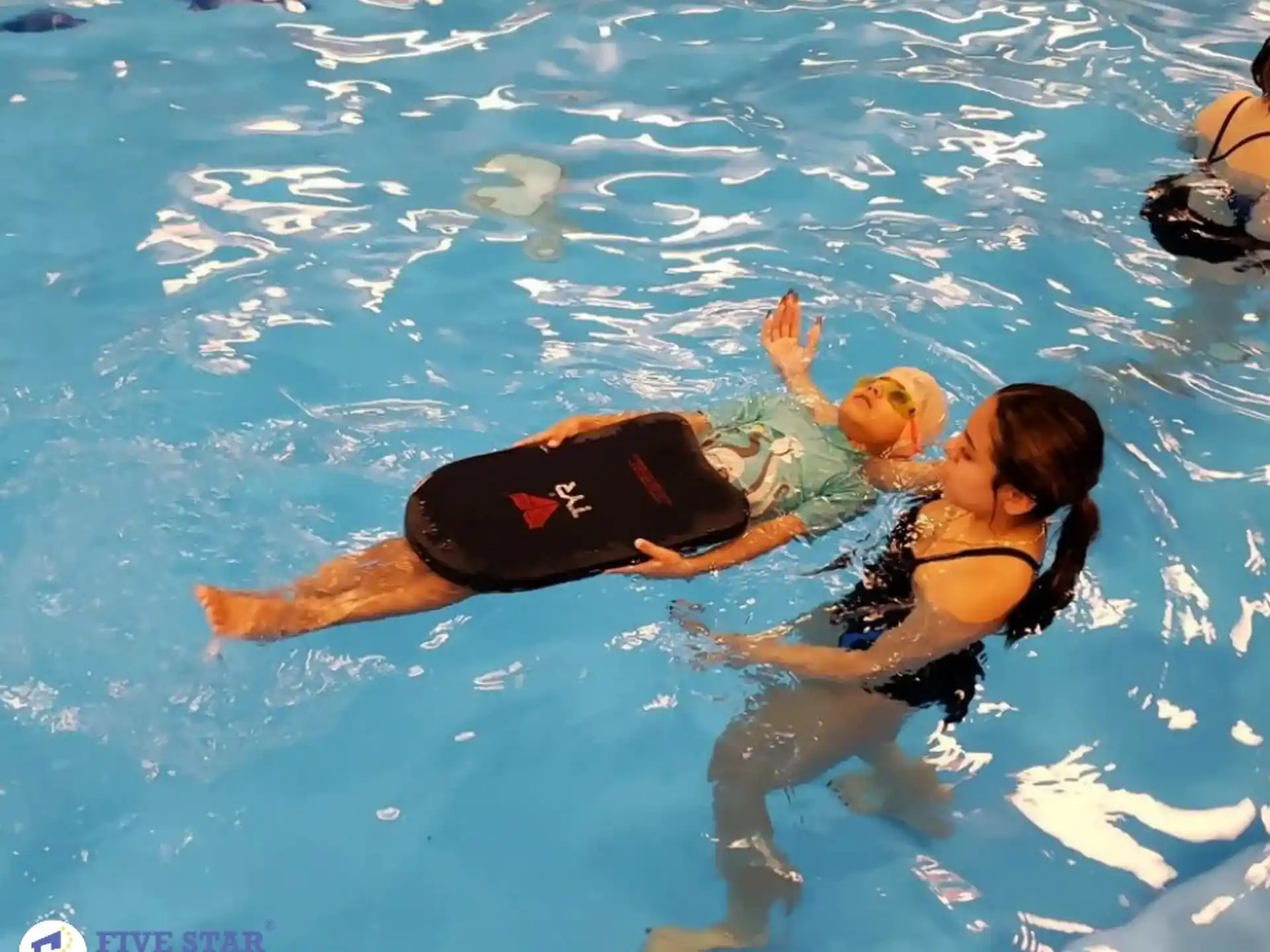 a person and a child in a pool