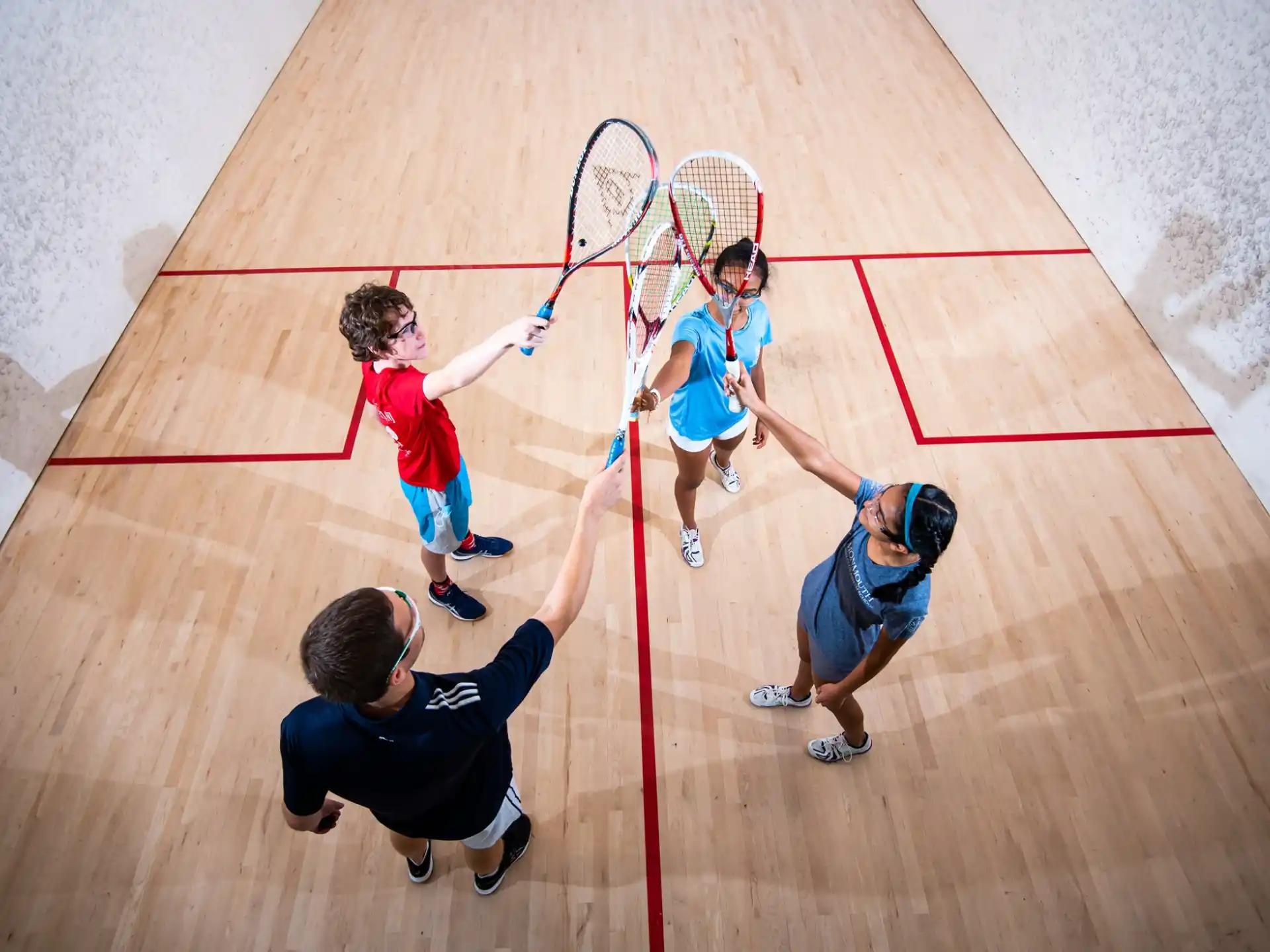 a group of people playing tennis