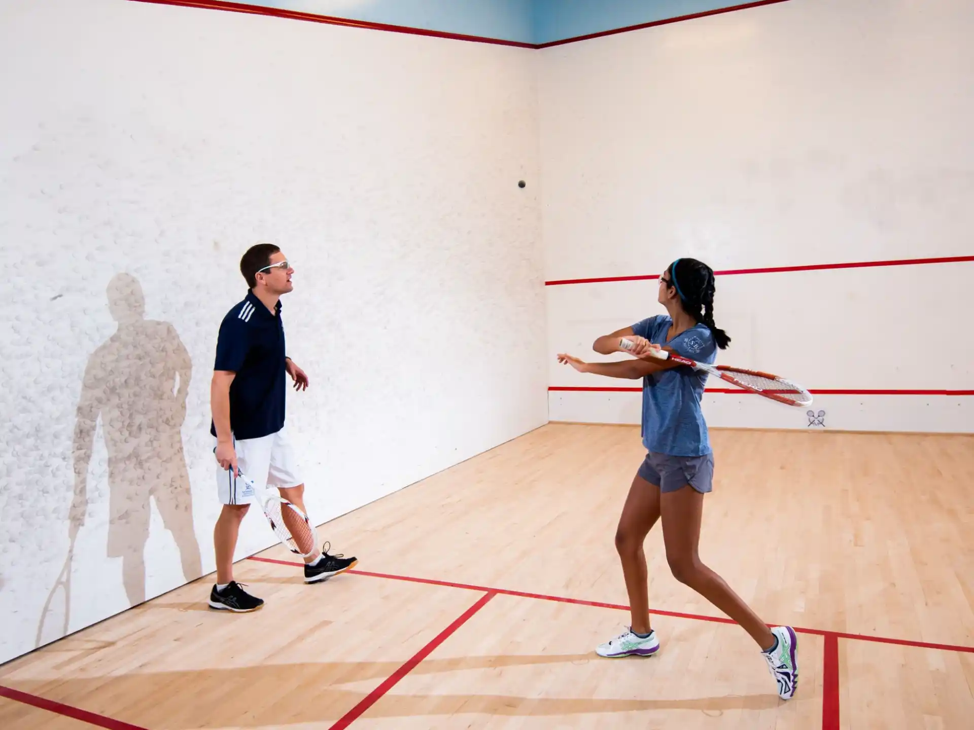a man and a woman playing a game of sword fighting