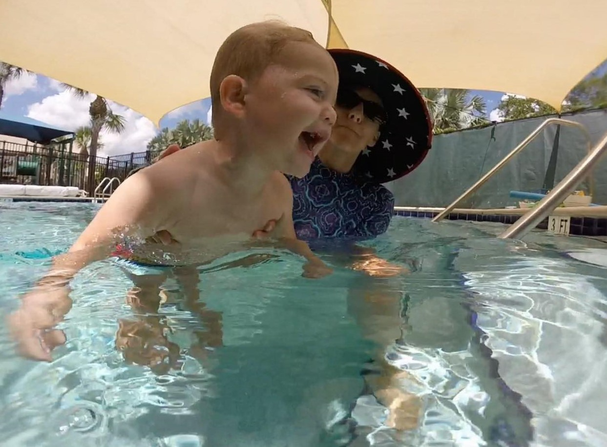 a person and a baby in a pool