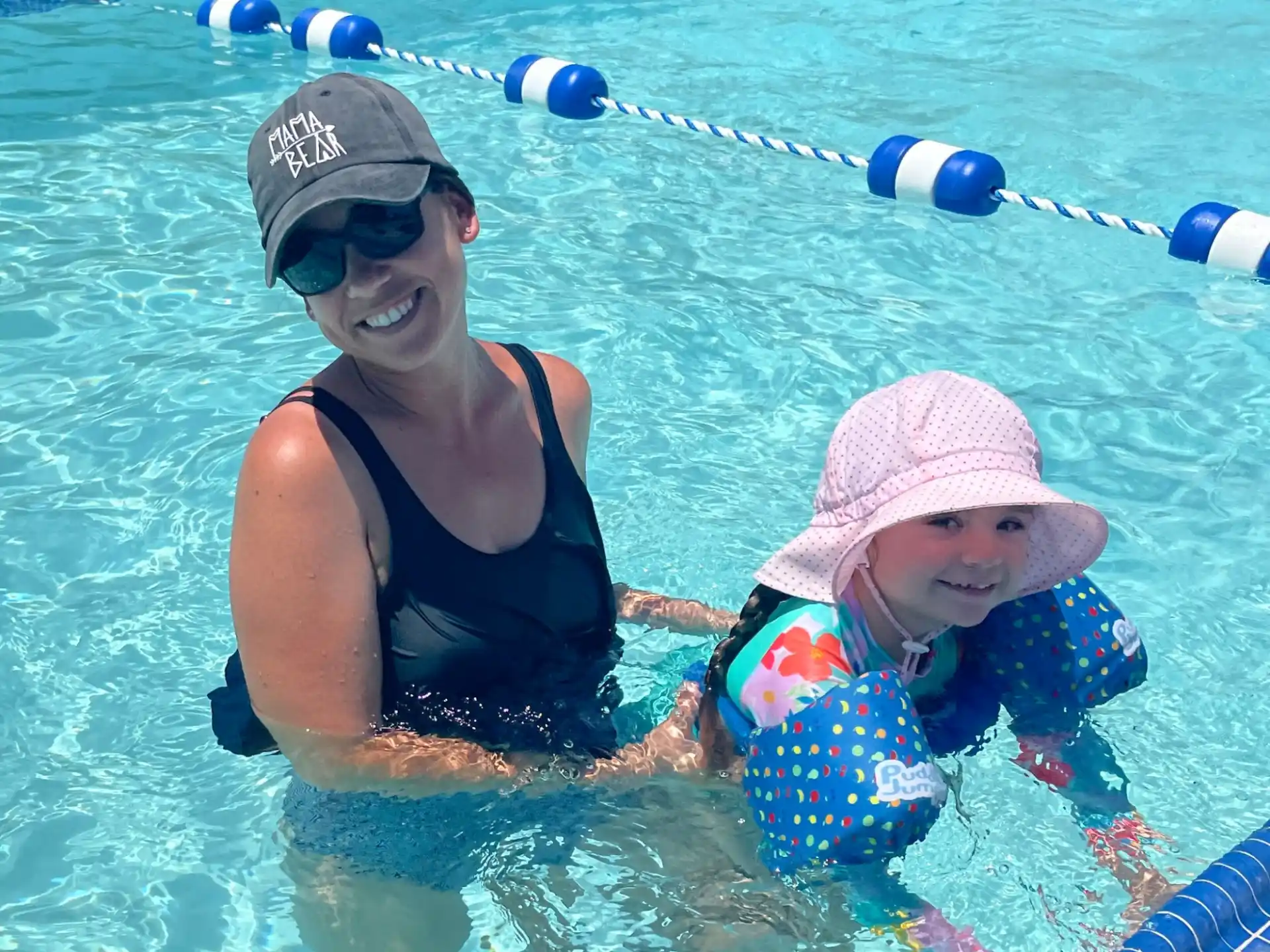 a person and a baby in a pool