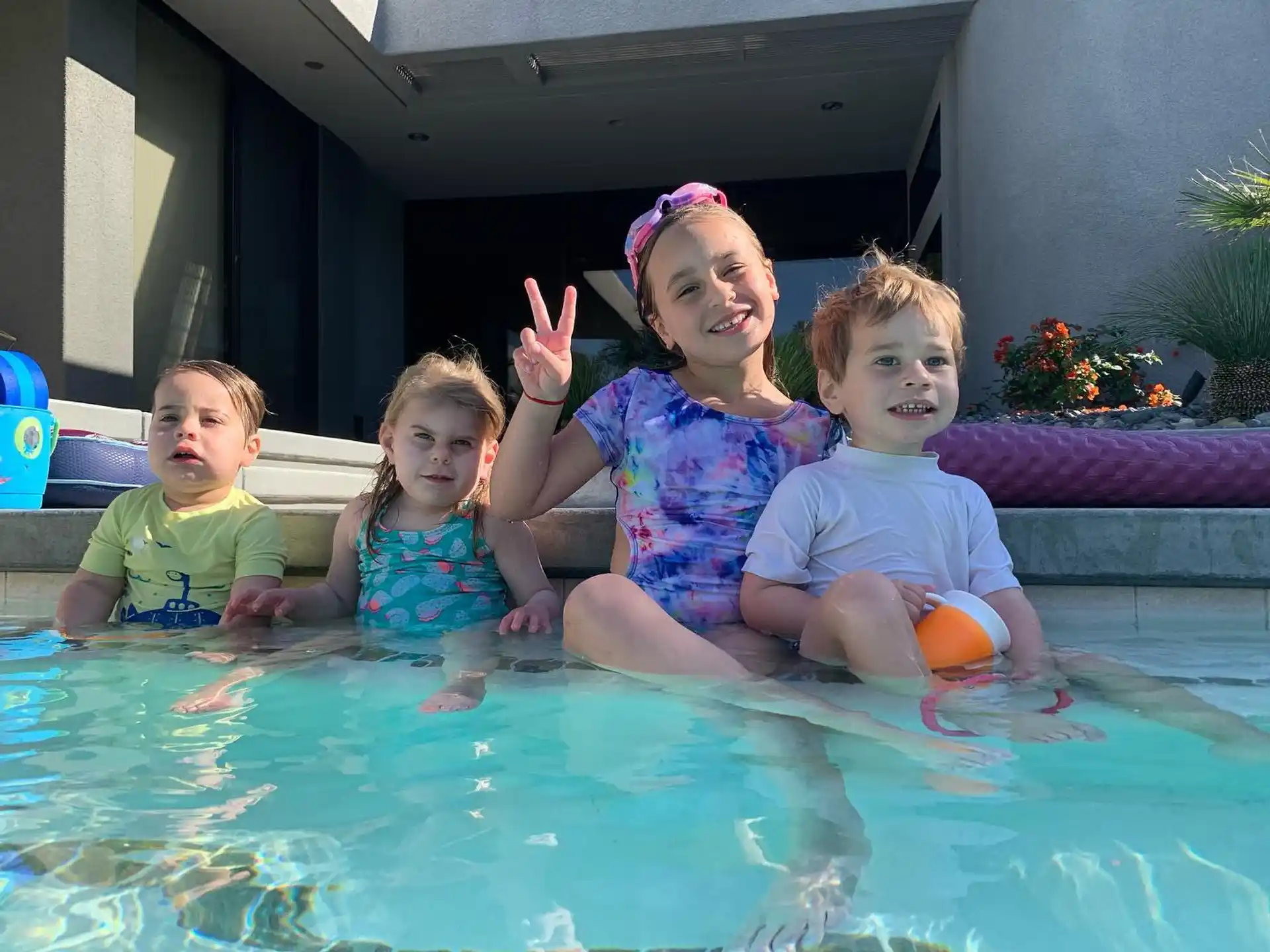 a group of children in a pool