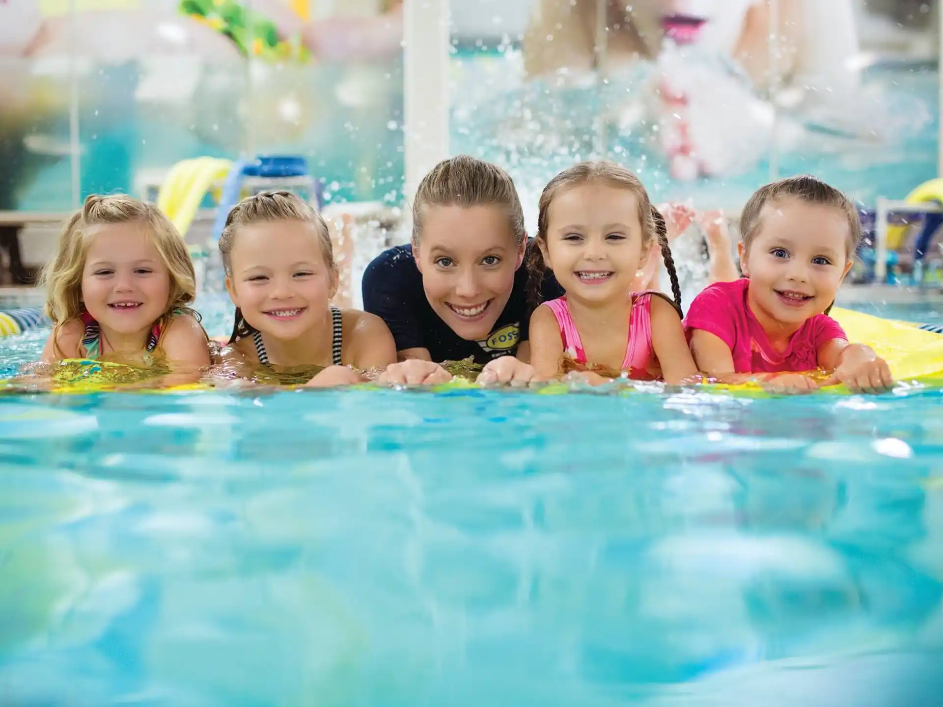 a group of children in a pool