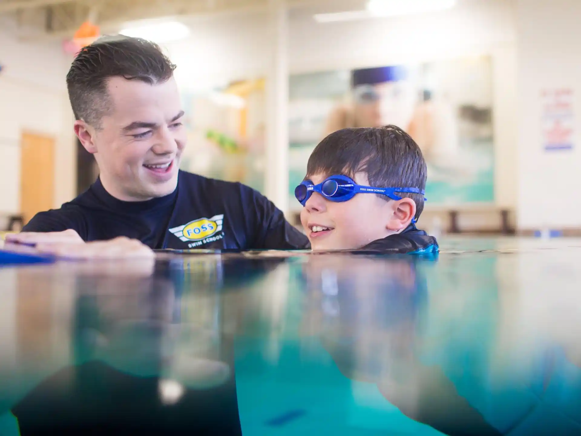 a man and a boy in a pool