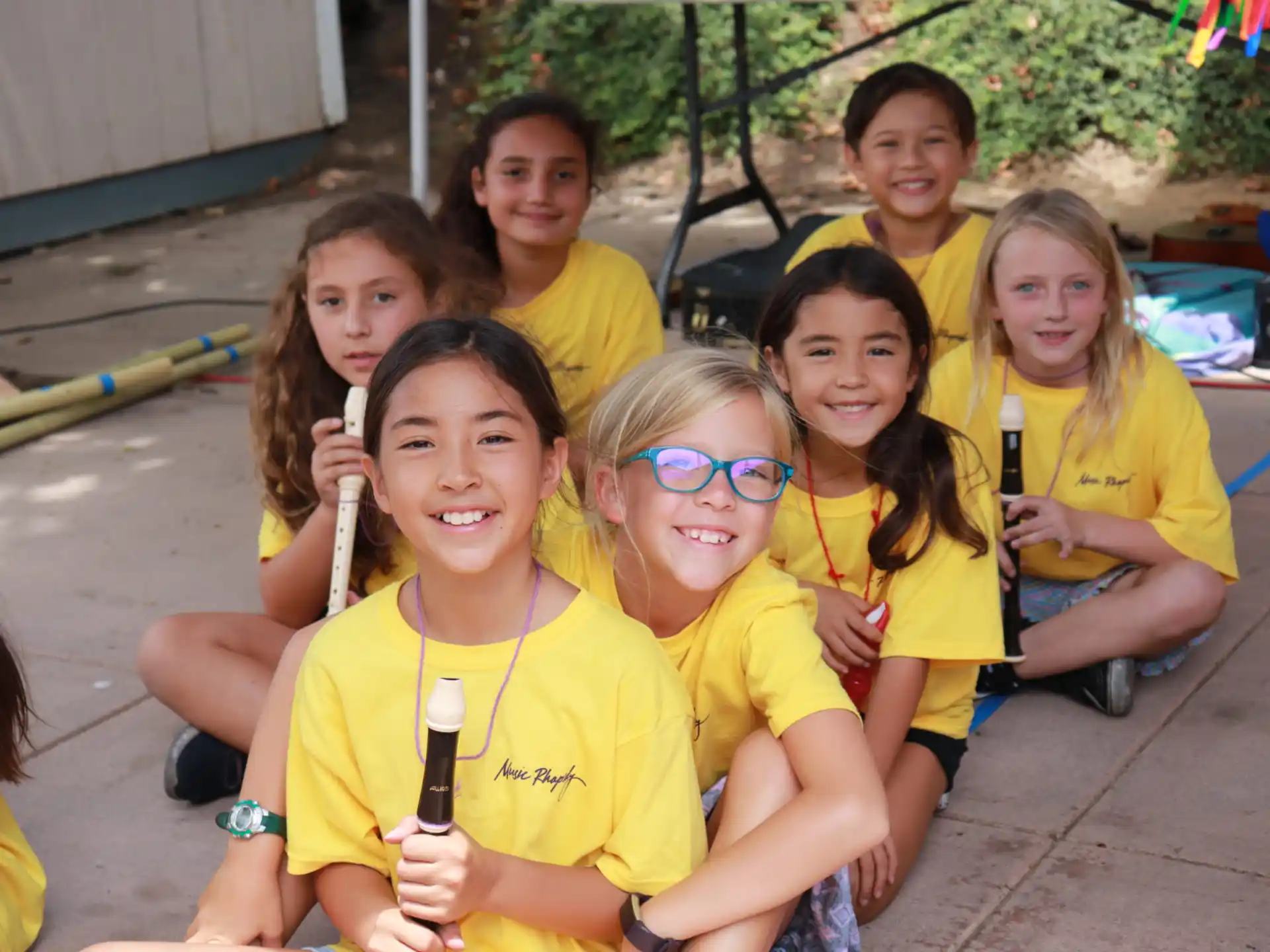 a group of children wearing yellow shirts