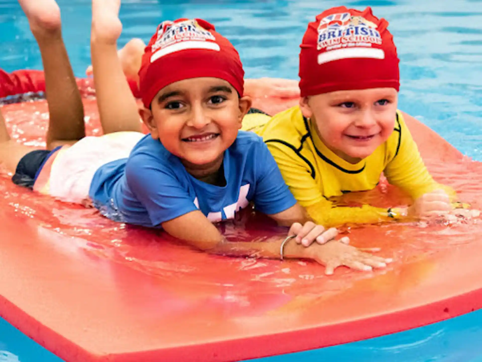 a couple of kids in a pool