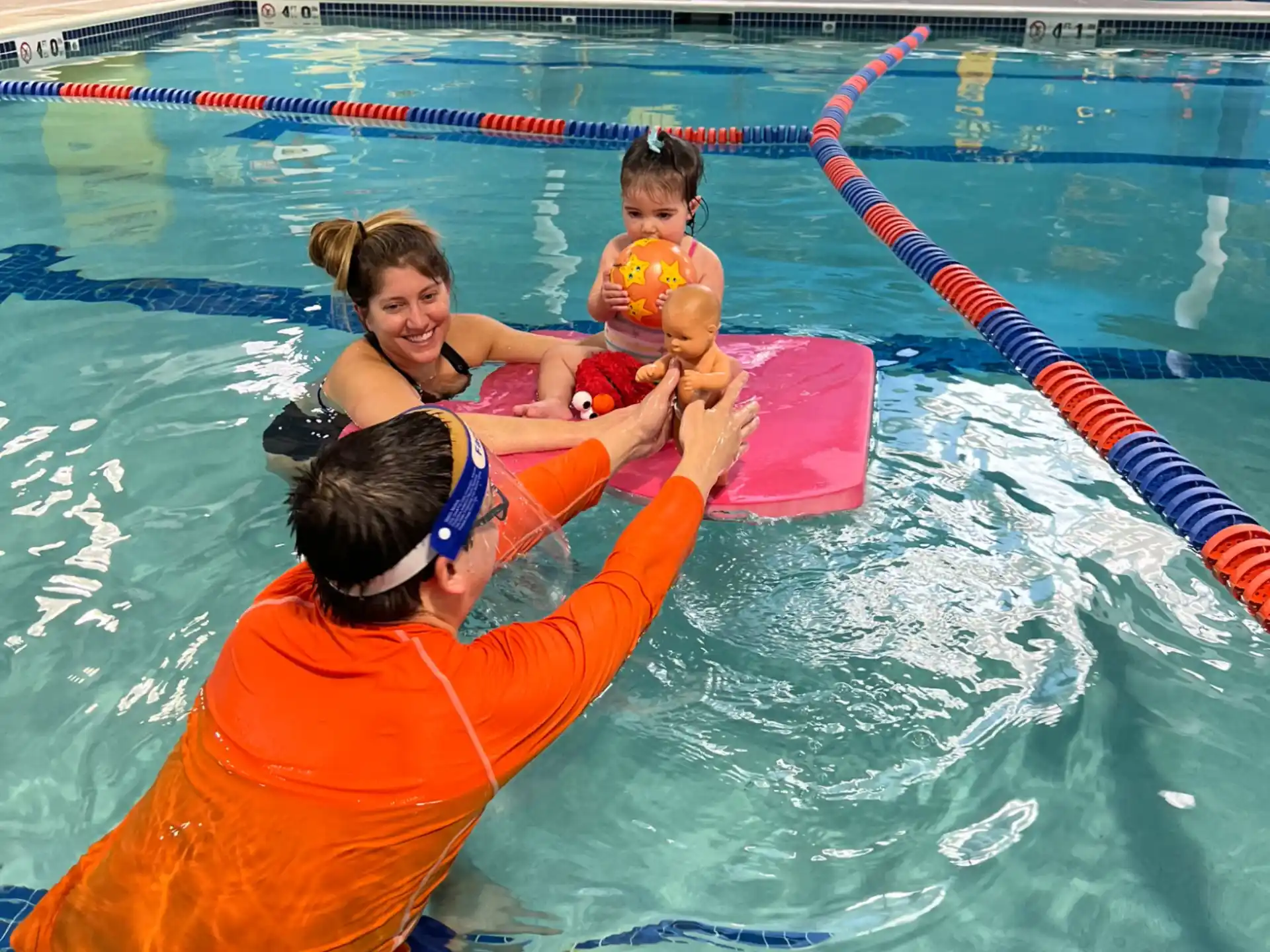 a person and a couple of kids in a pool
