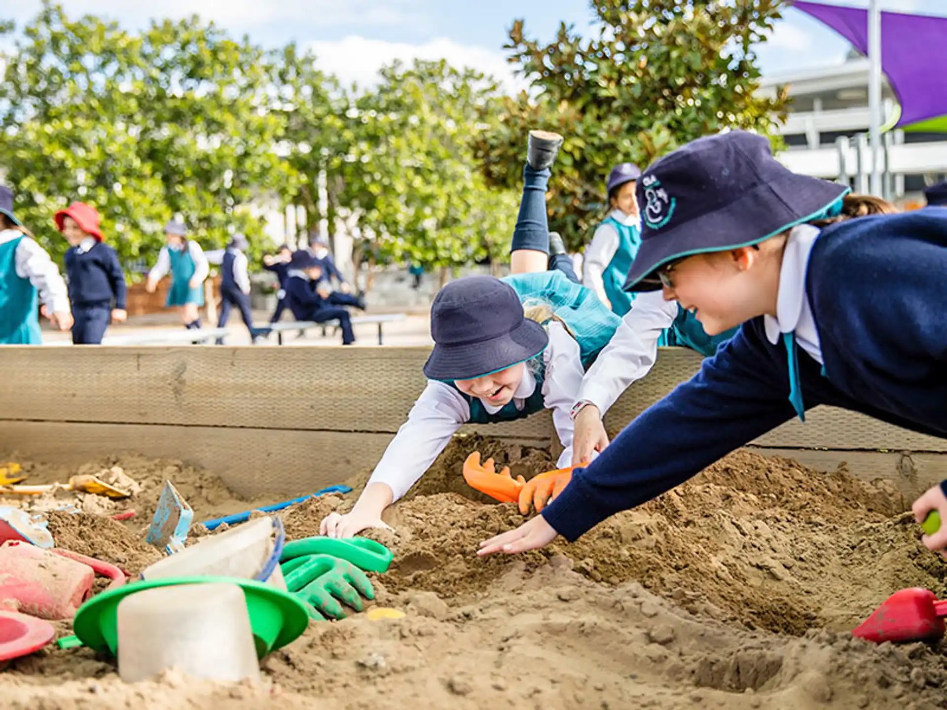 a few children playing in the sand